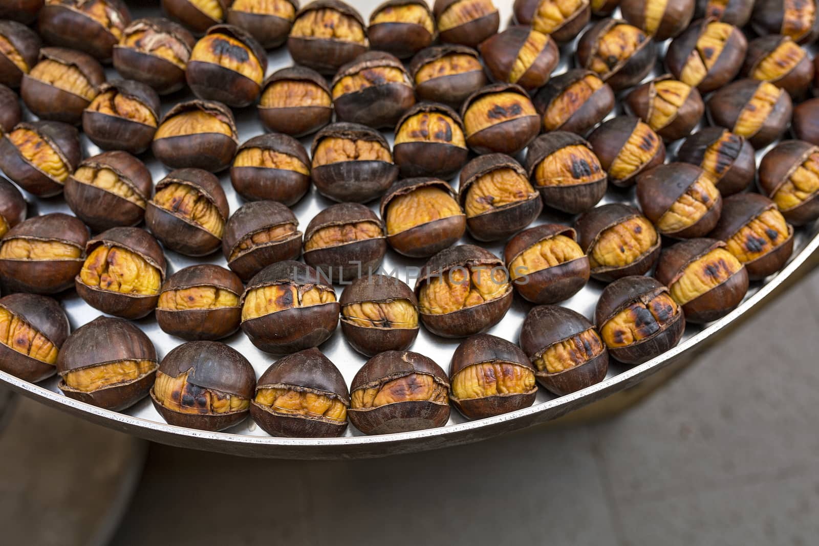 Roasted chestnuts nicely laid out on an iron tray by 977_ReX_977