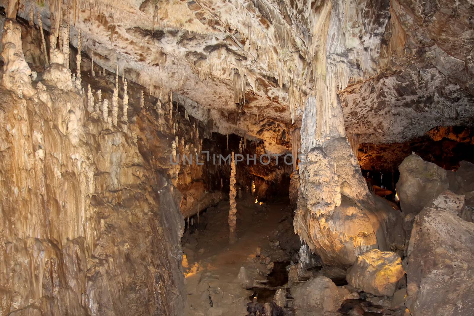 Cave with stalactites and stalagmites. Speleothems, cave formations. Geological formation karst. Karst cave.