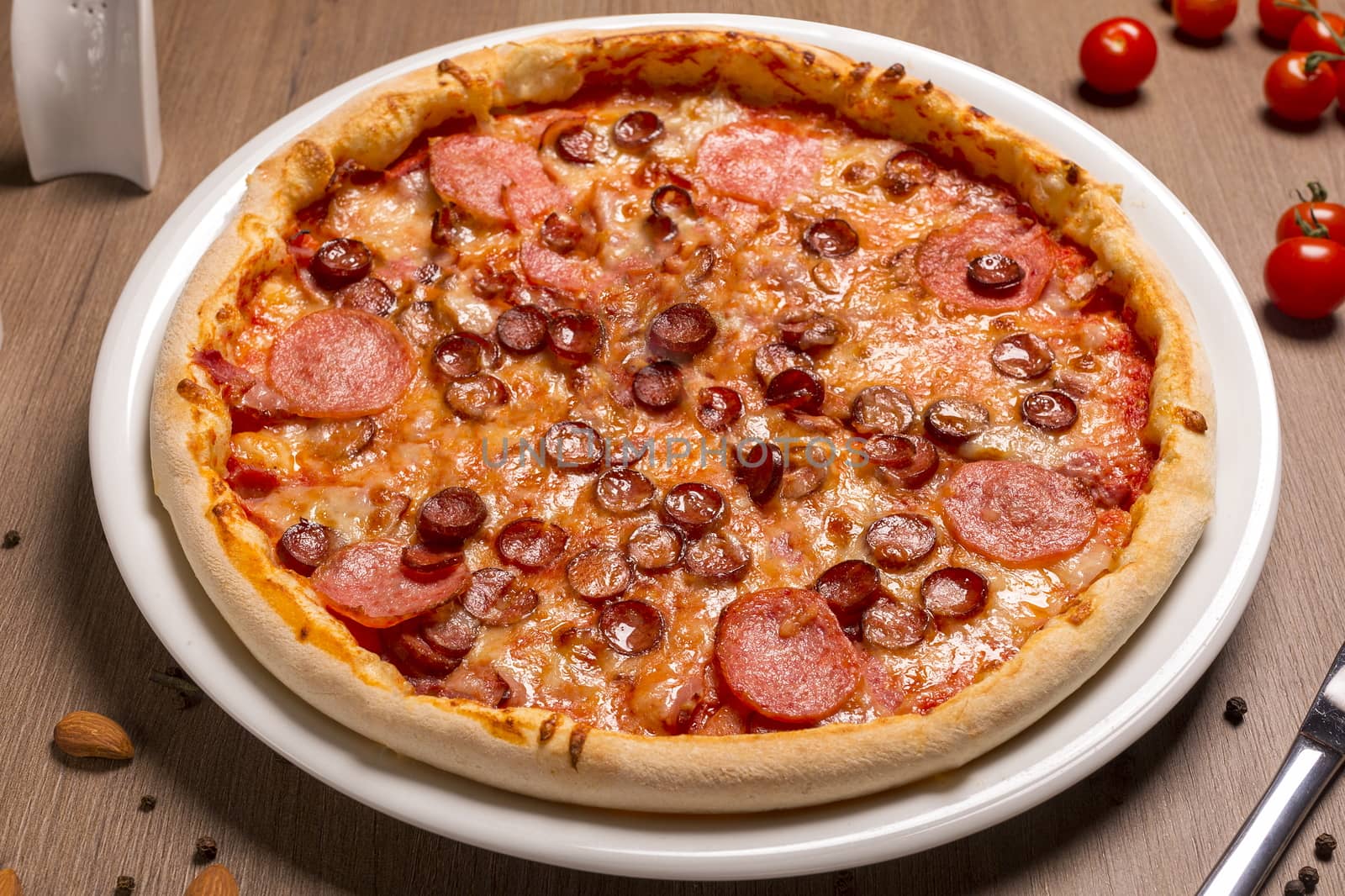 Pizza is super meat thin cake, tomato sauce, beef balyk, ham, bacon, hunting sausages Italian salami, mozzarella, basil.