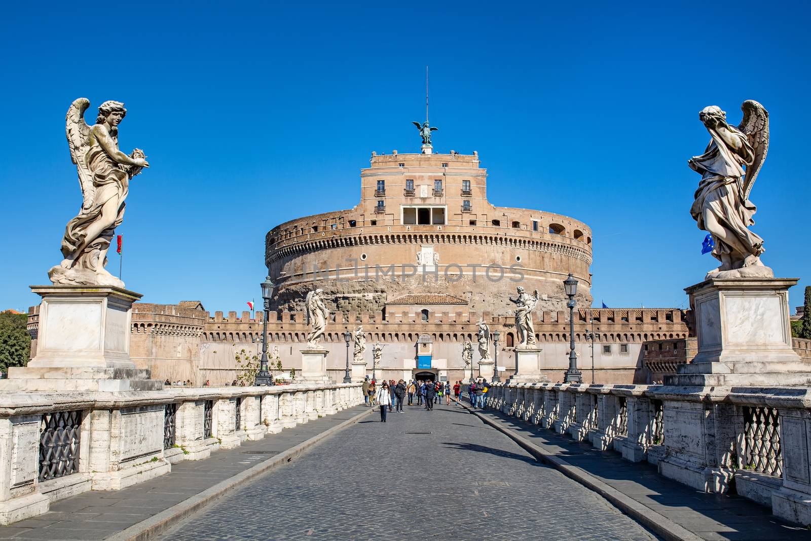 28.02.2020 in Rome, Italy. Frontal view of the Castel Sant'Angelo against the blue sky. Tourists walk nearby
