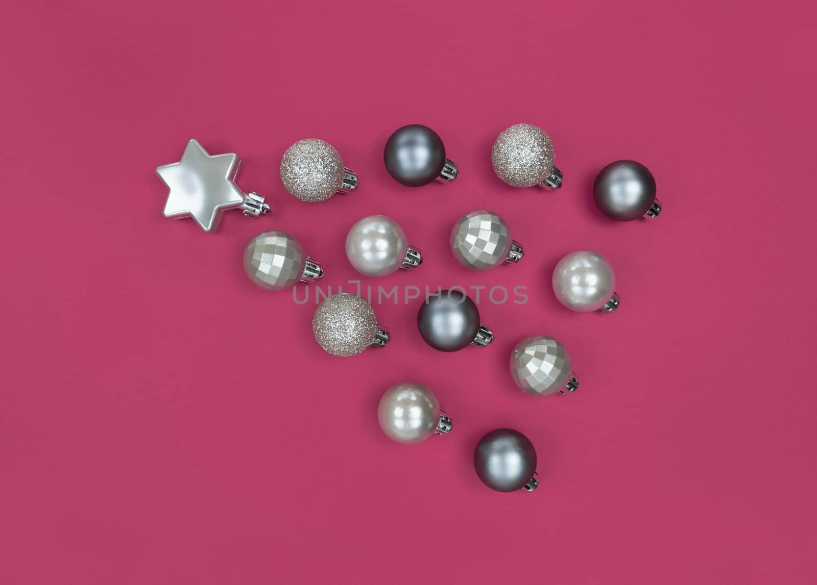 Comet from Christmas tree baubles on pink paper.