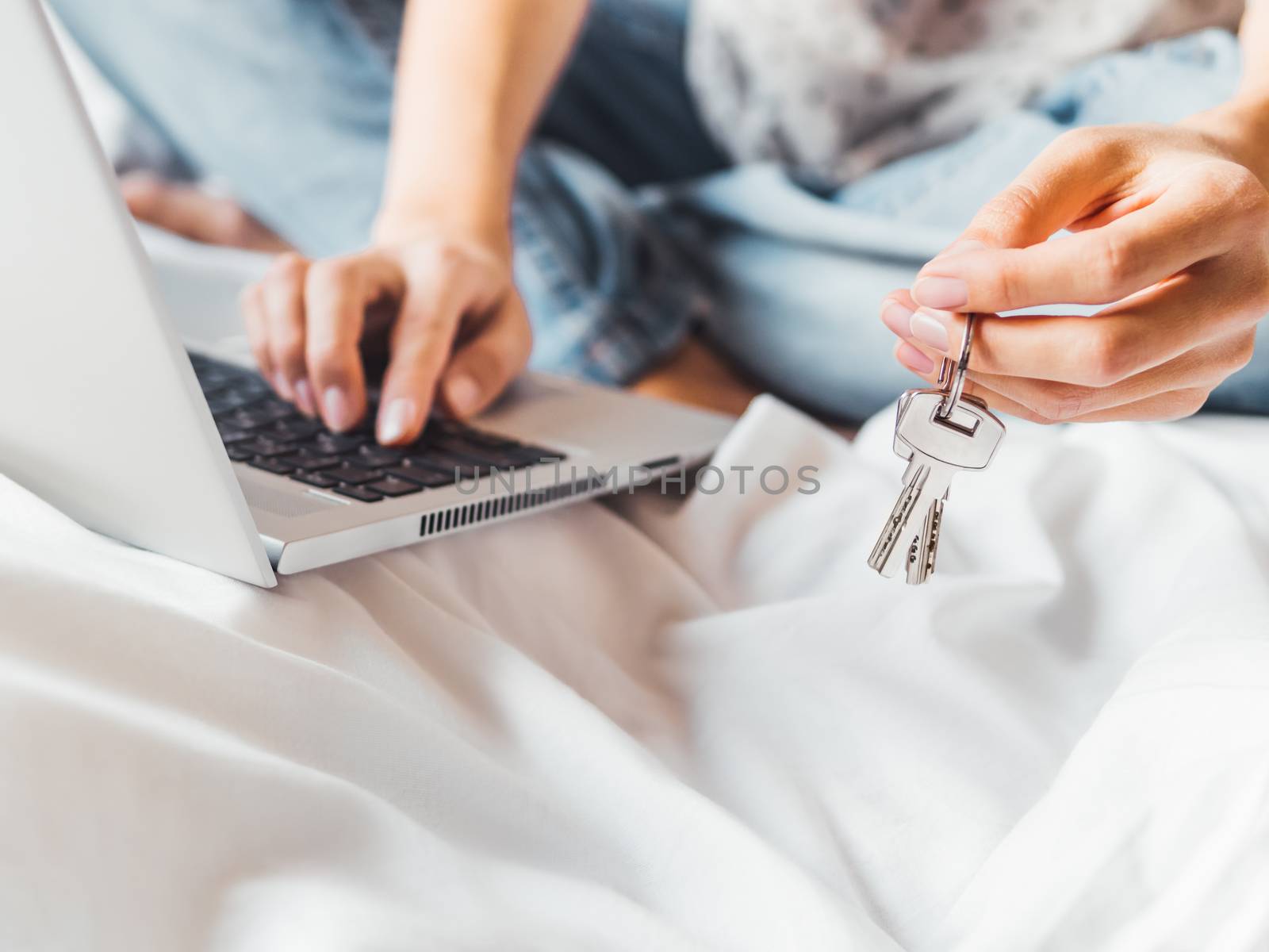 Woman uses laptop in bed to pay bills or book a hotel room. Meta by aksenovko