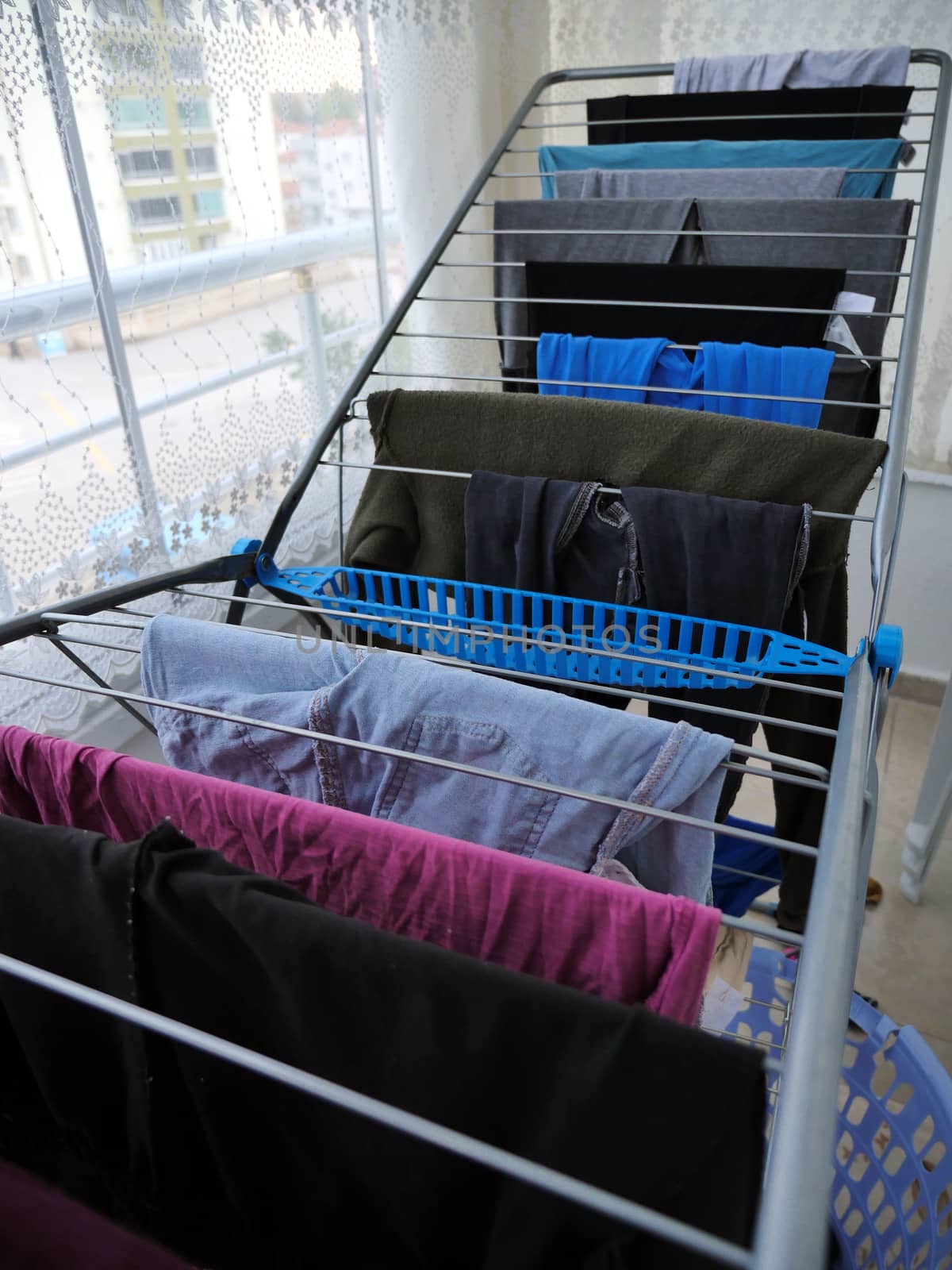 Drying clothes on the balcony in winter, drying clothes on the glass balcony, wet clothes are dried,