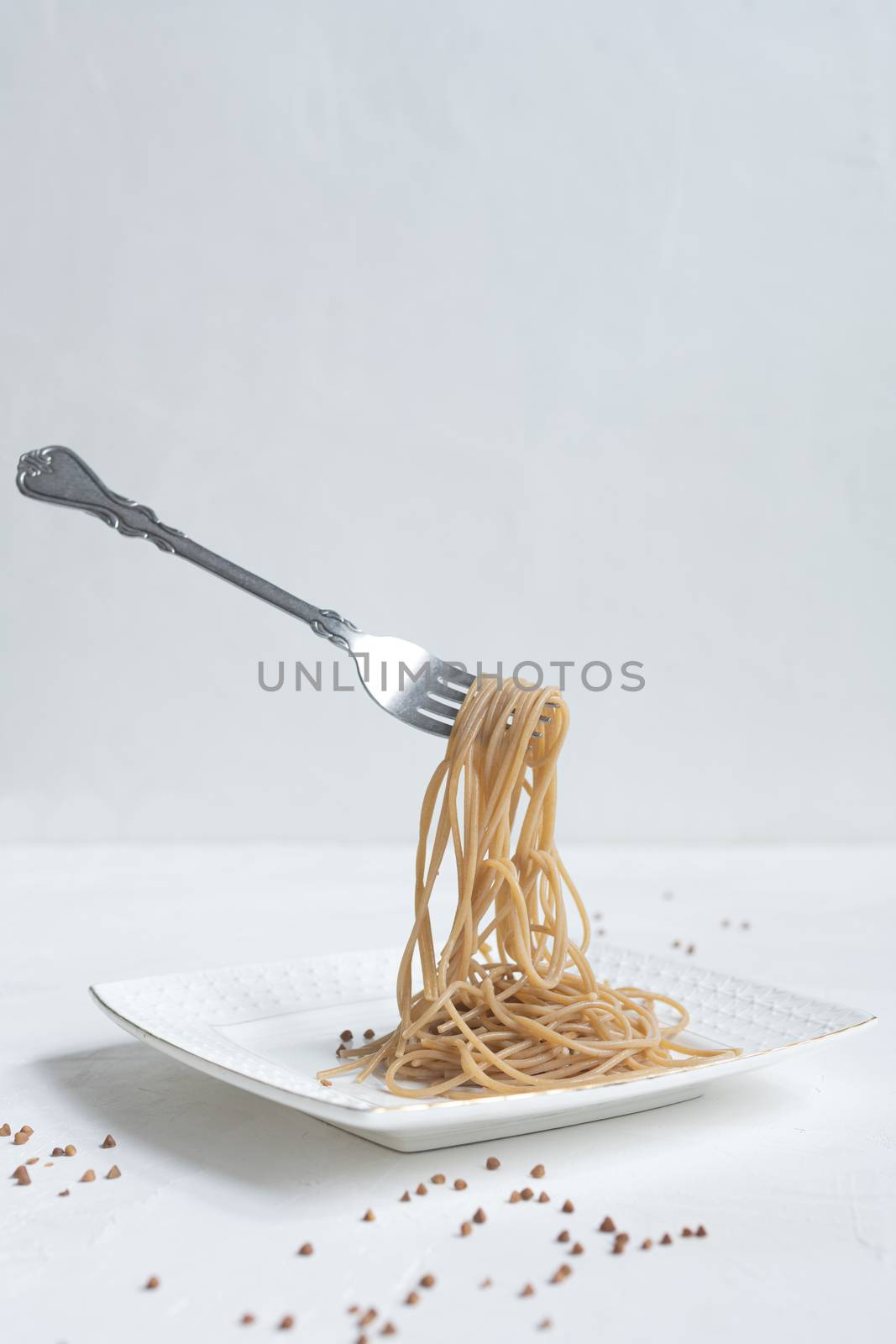 spaghetti made from buckwheat on a white table by sashokddt