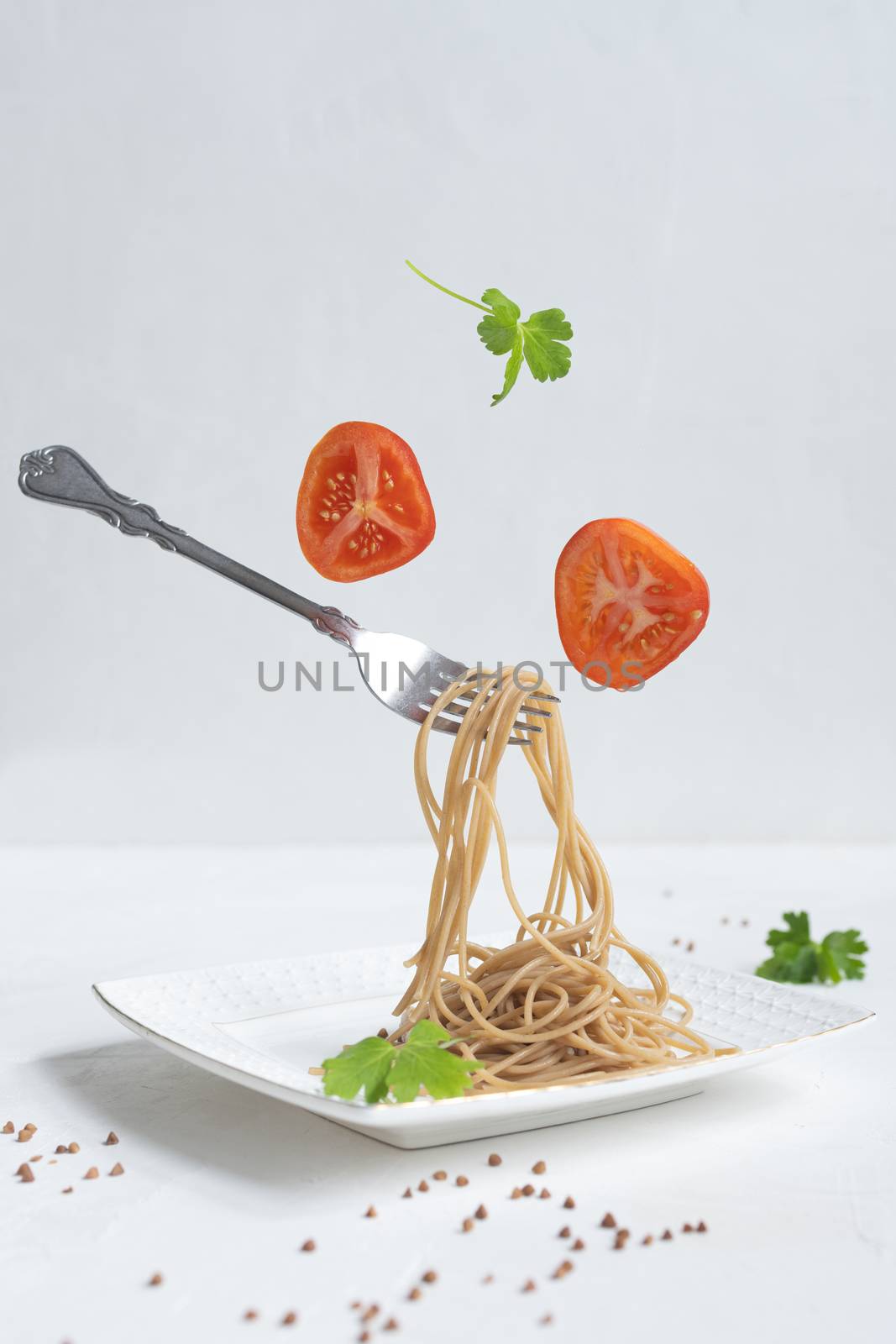 spaghetti made from buckwheat on a white table.