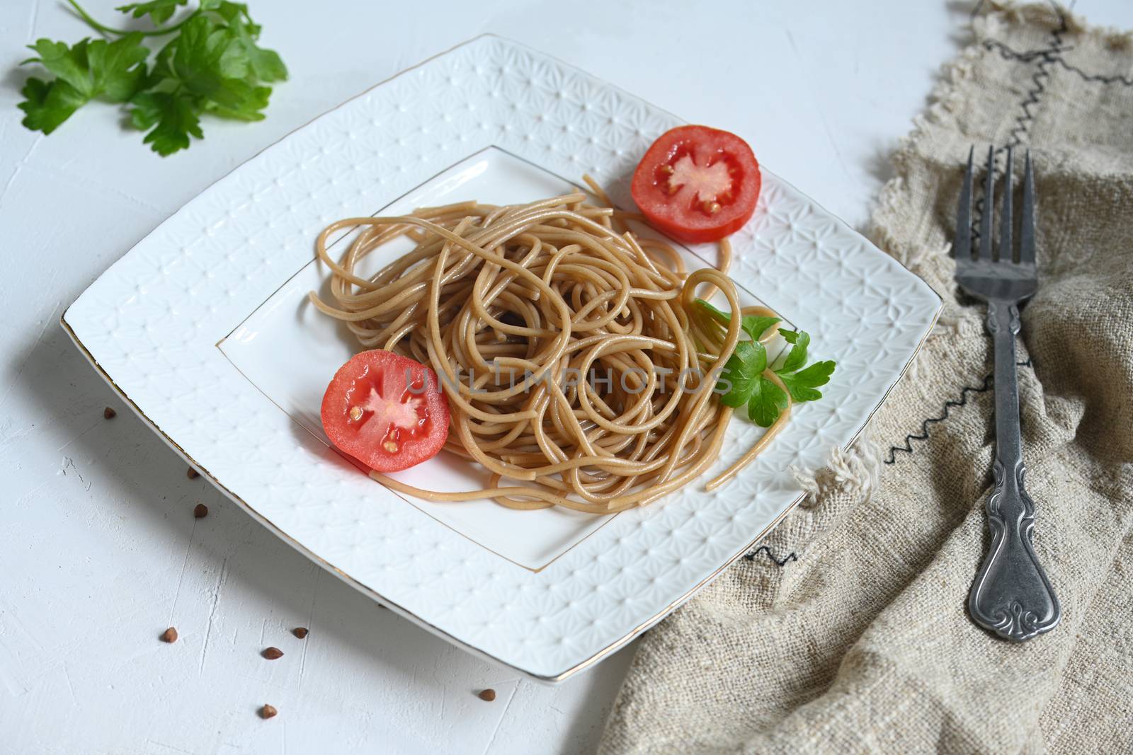 spaghetti made from buckwheat on a white table by sashokddt