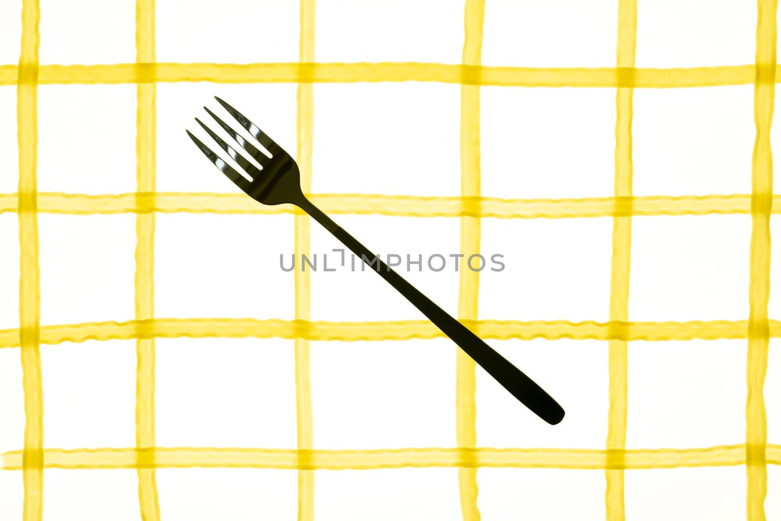 spaghetti pasta laid out in the form of a cell with fork and knife by sashokddt