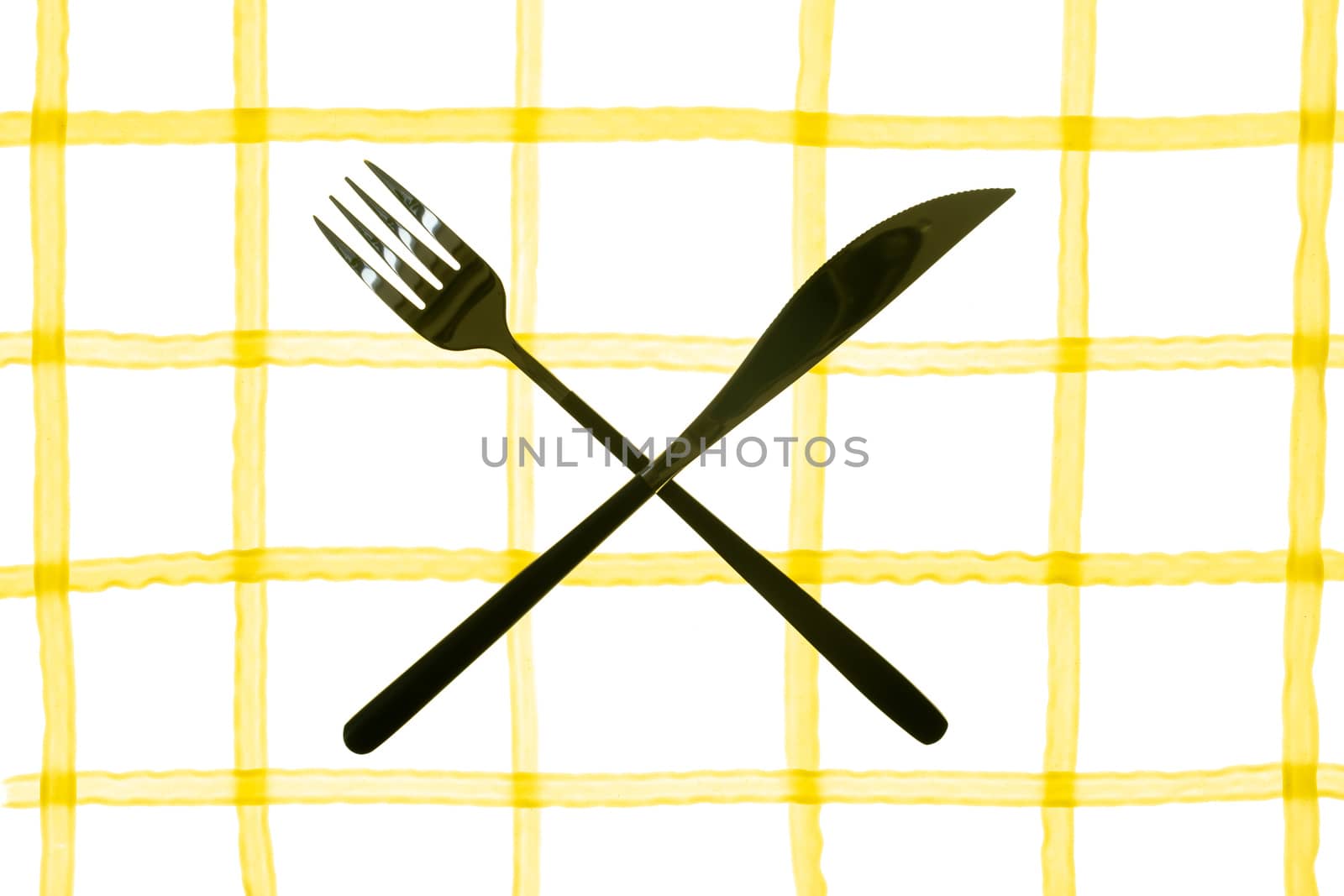 spaghetti pasta laid out in the form of a cell with fork and knife by sashokddt