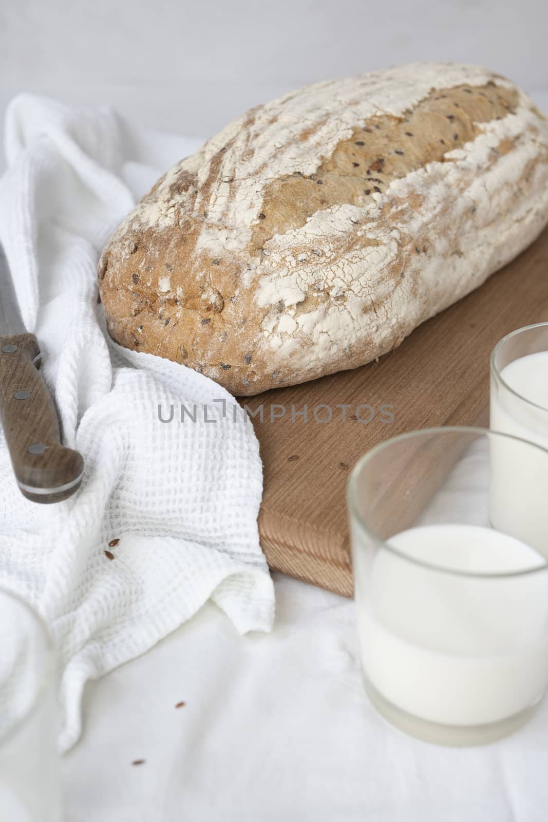 Wheat bread, a jug of milk and bread with sesame seeds by sashokddt