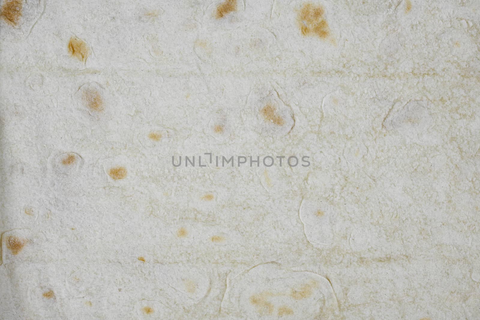 Texture of thin traditional freshly baked homemade oriental bread. Close-up Armenian pita bread - lavash as a textured bread background. by sashokddt