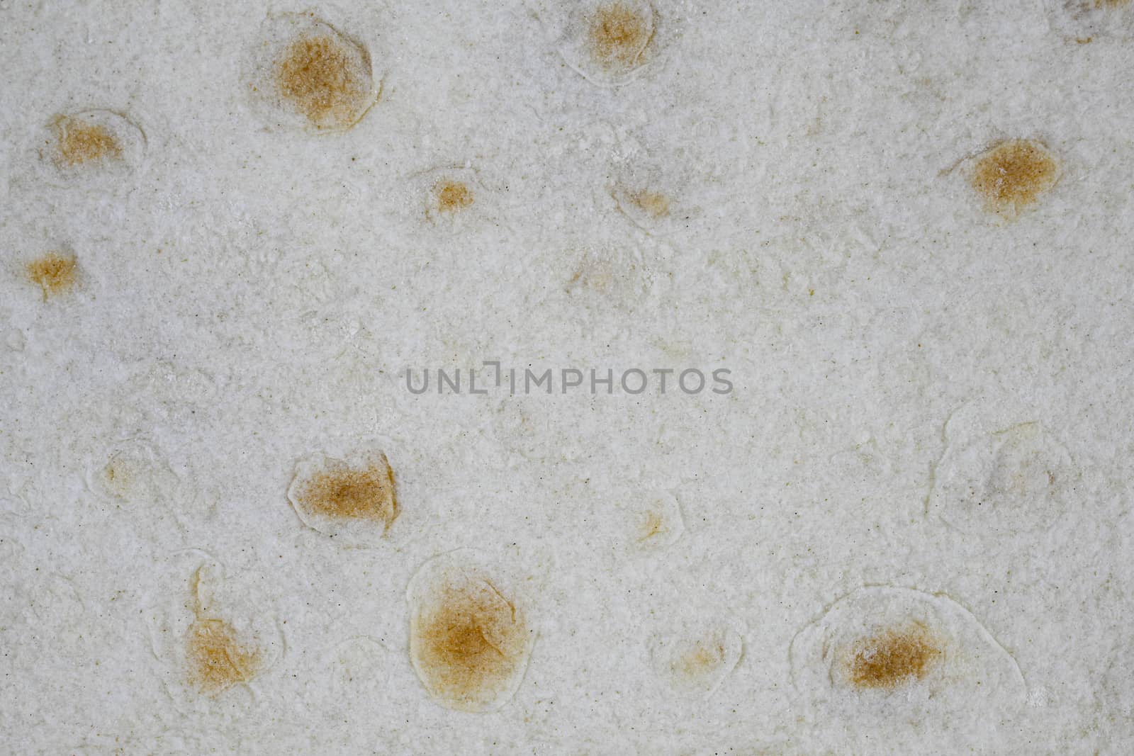 Texture of thin traditional freshly baked homemade oriental bread. Close-up Armenian pita bread - lavash as a textured bread background