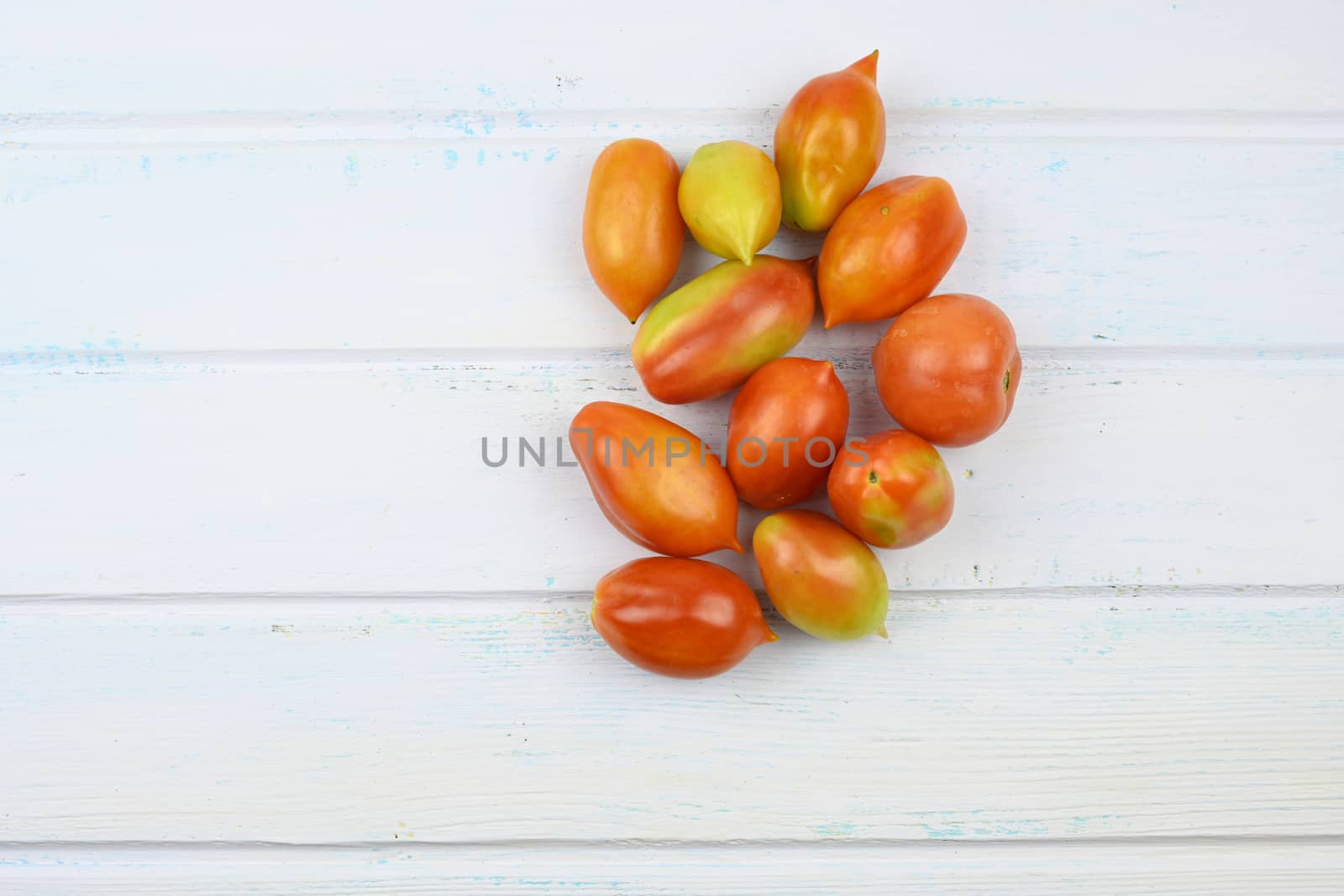 Homegrown tomatoes on vintage white wooden table.