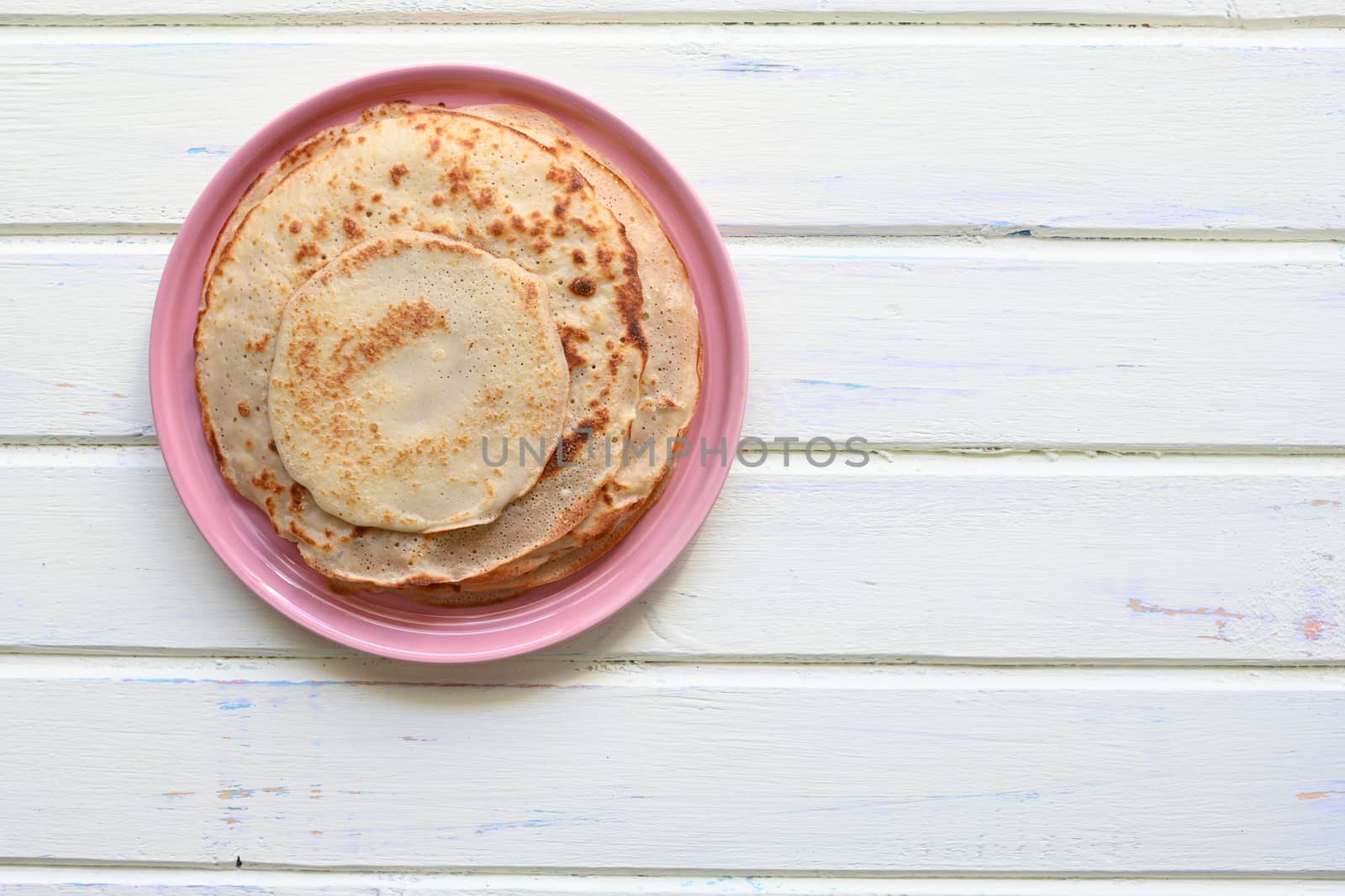 large pancakes with jam on white background