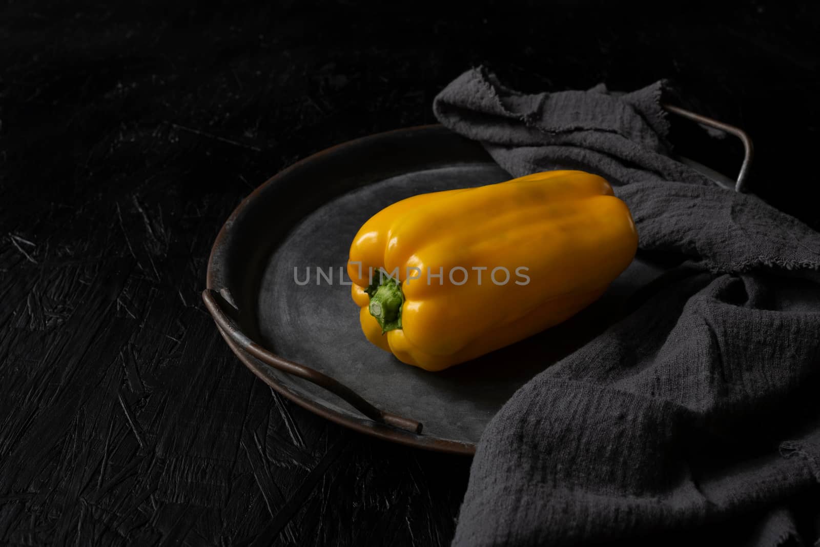 Image of yellow raw pepper on black background by sashokddt