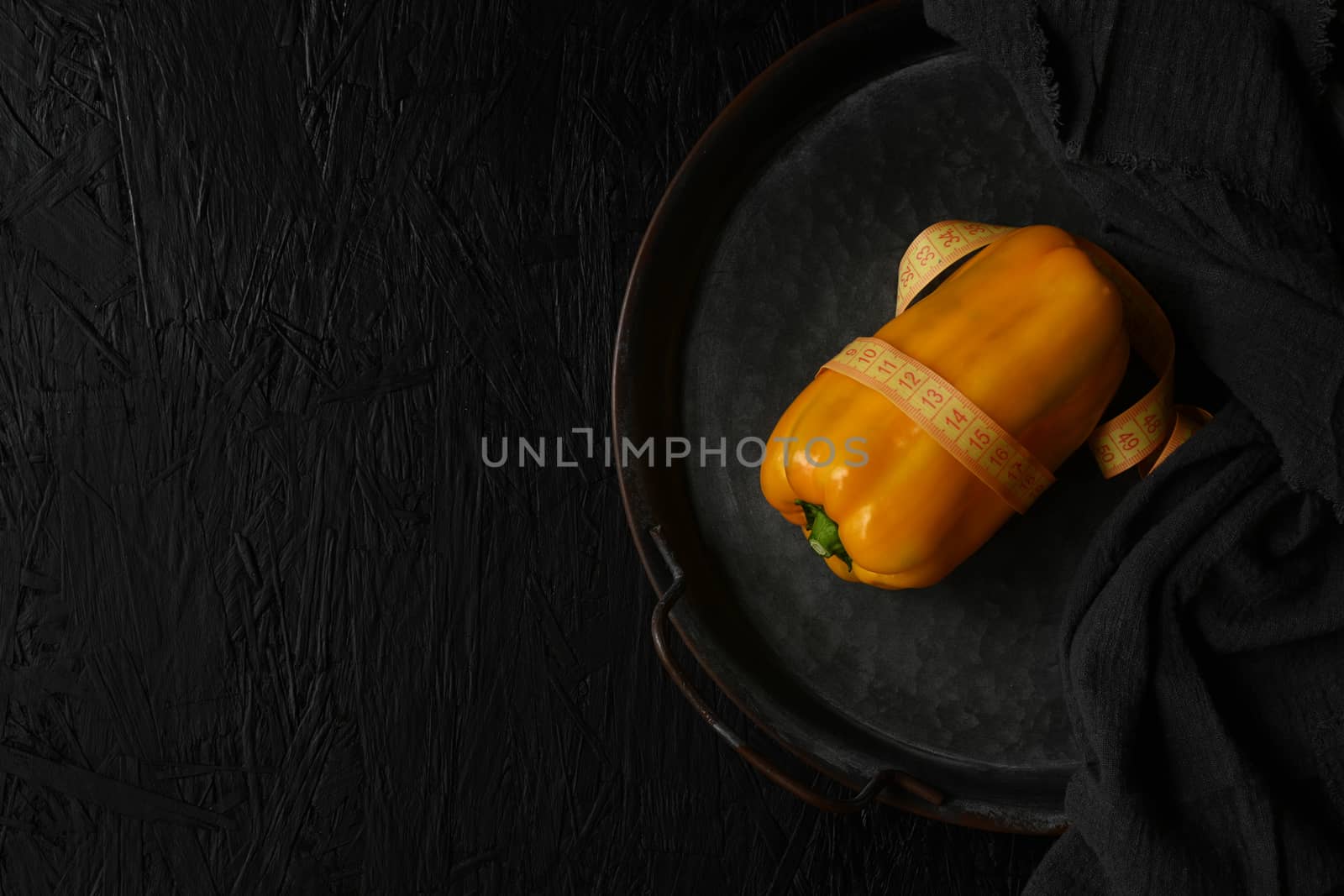 Image of yellow raw pepper on black background by sashokddt