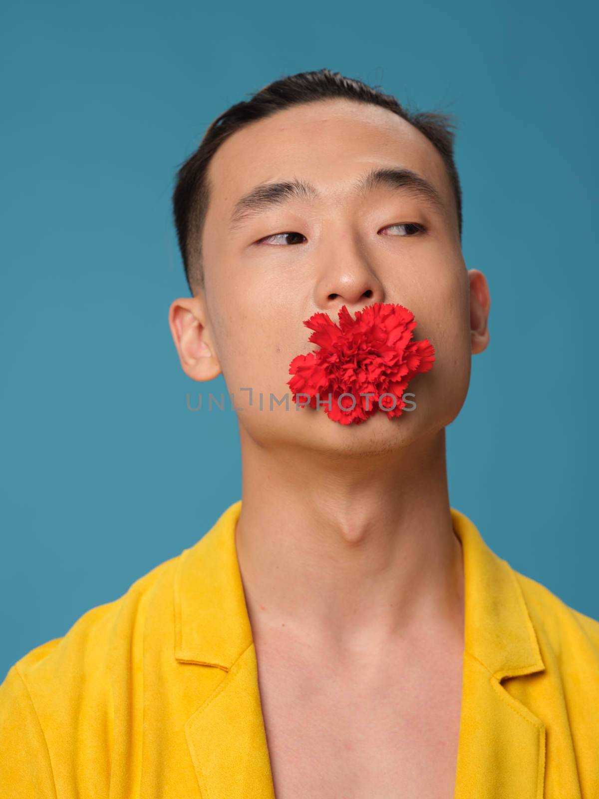 Handsome Asian man with a flower in his teeth and a yellow coat fashion style romance by SHOTPRIME