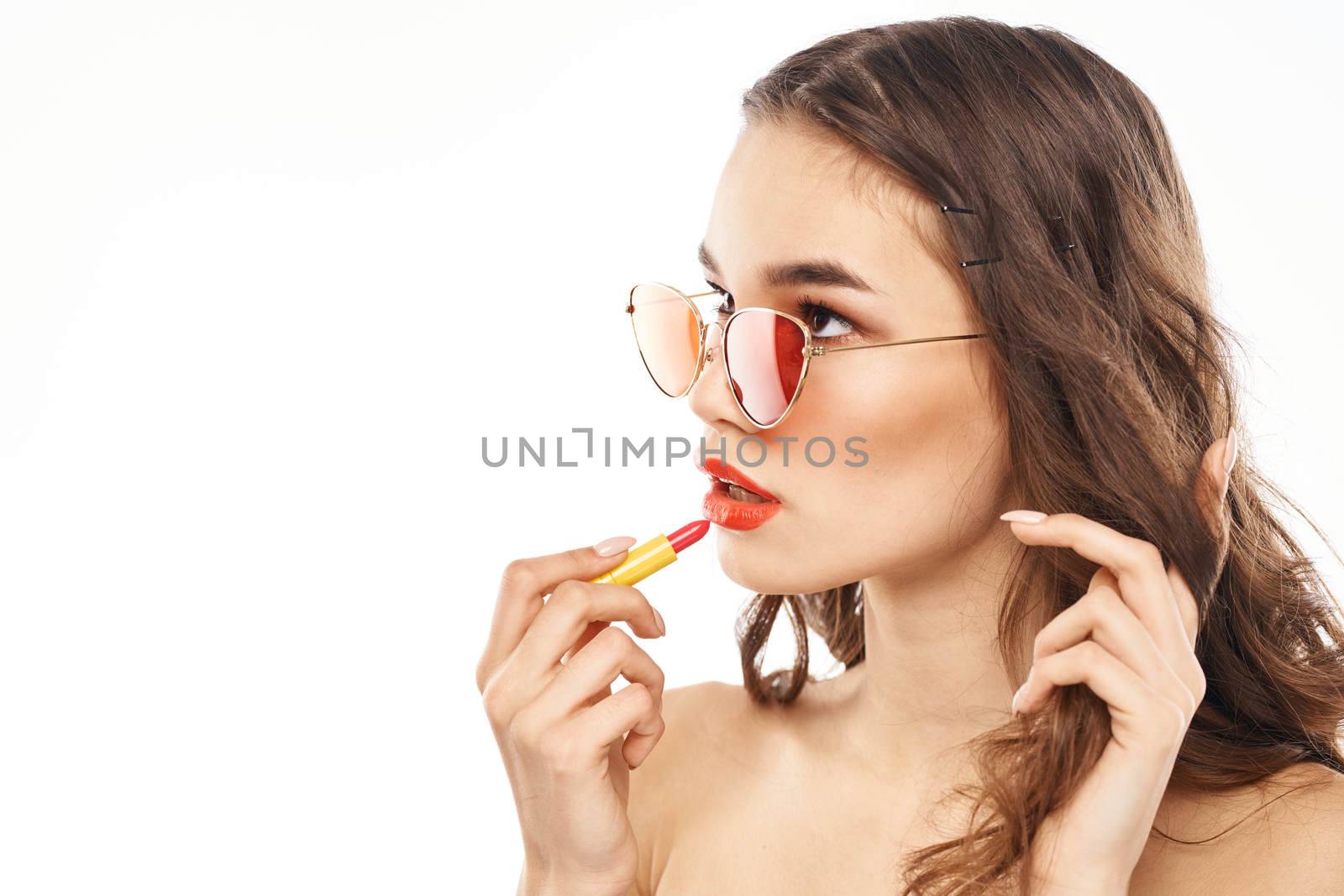 Fashionable brunette in sunglasses with makeup lipstick model. High quality photo