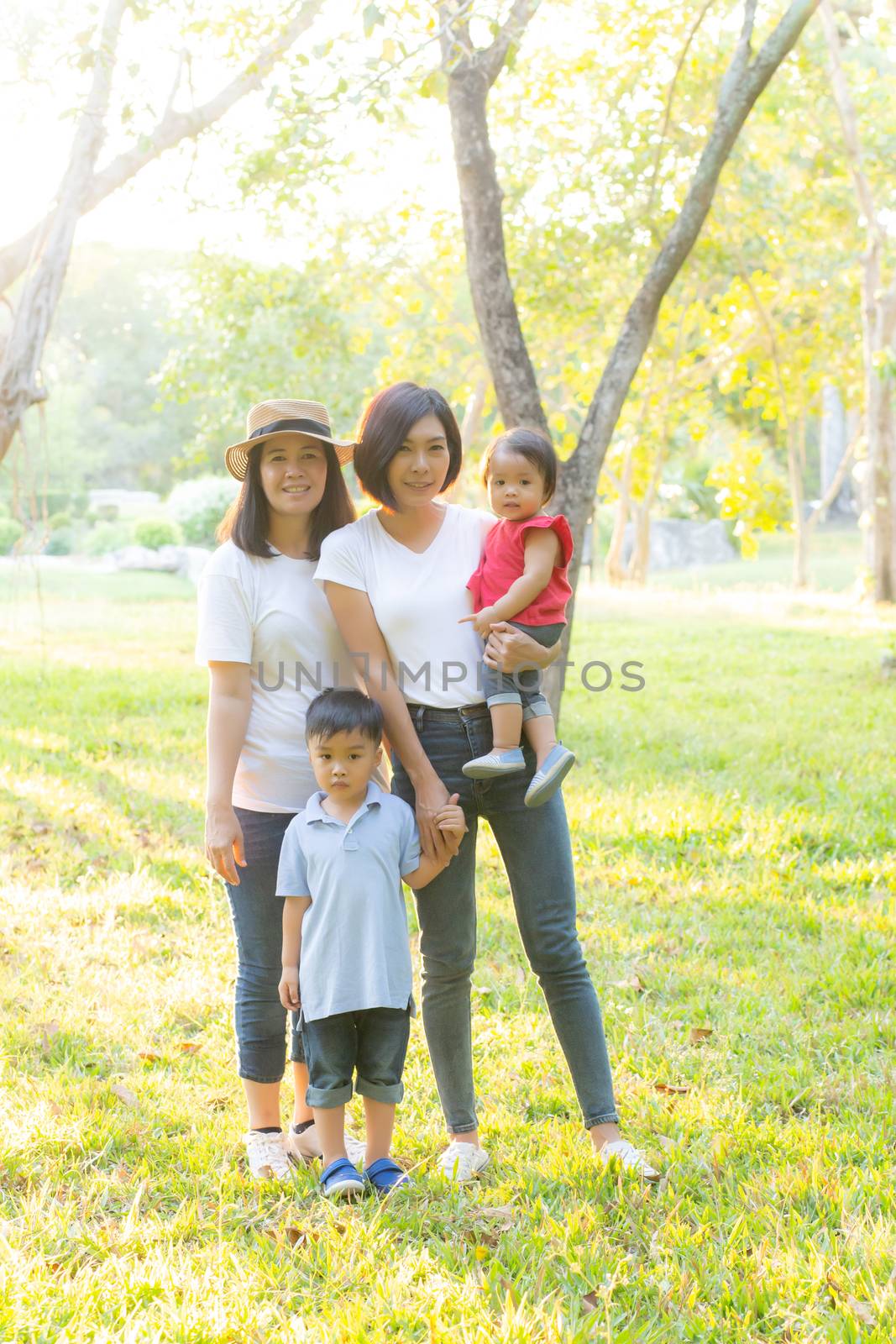 Beautiful young asian parent family portrait picnic in the park, by nnudoo