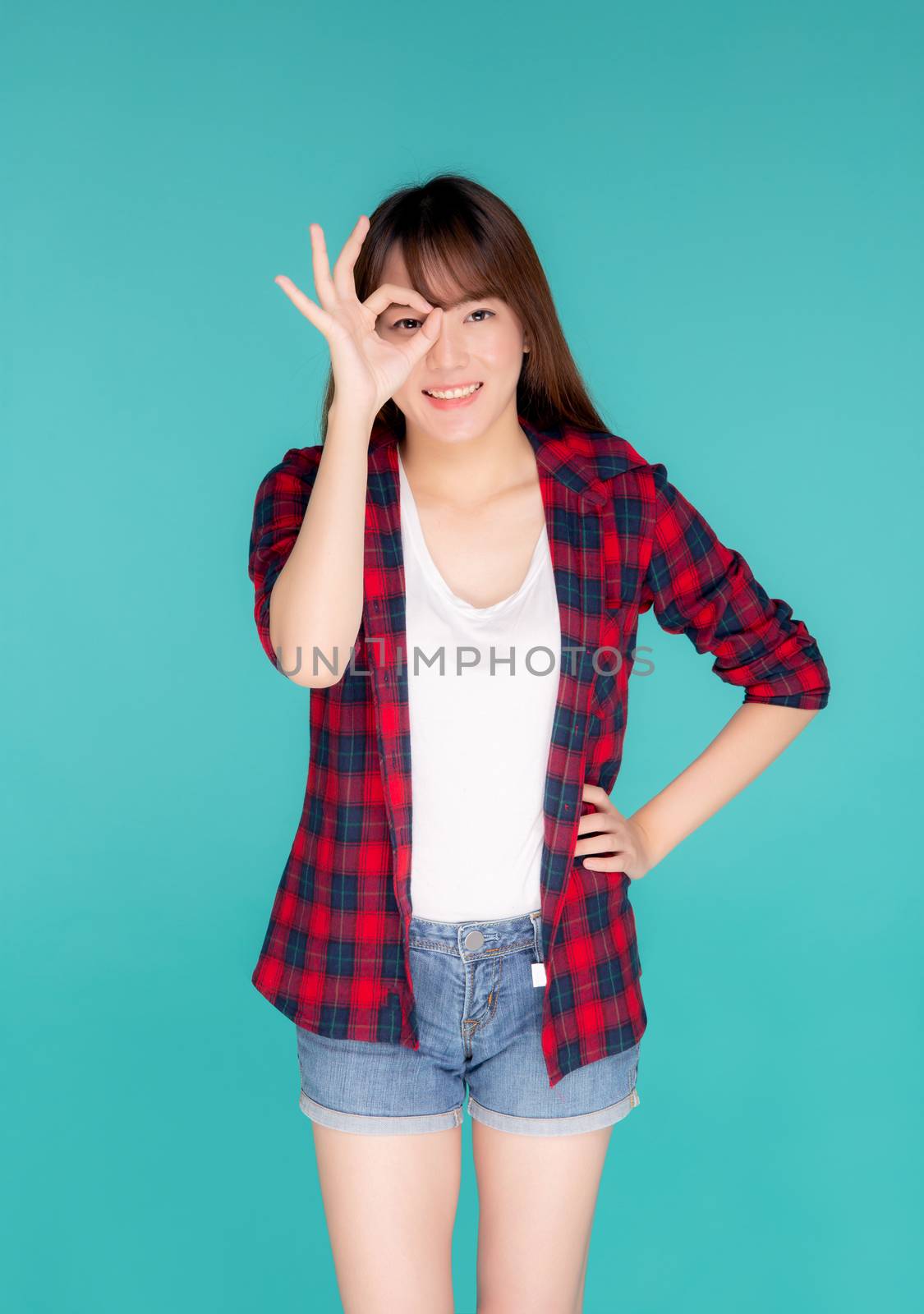 Beautiful happy young asian woman wear travel summer gesture ok  by nnudoo