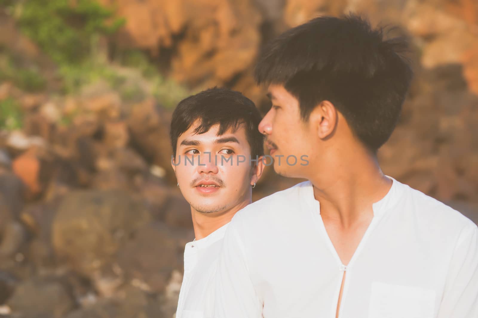 Homosexual portrait young asian couple sitting hug together on r by nnudoo