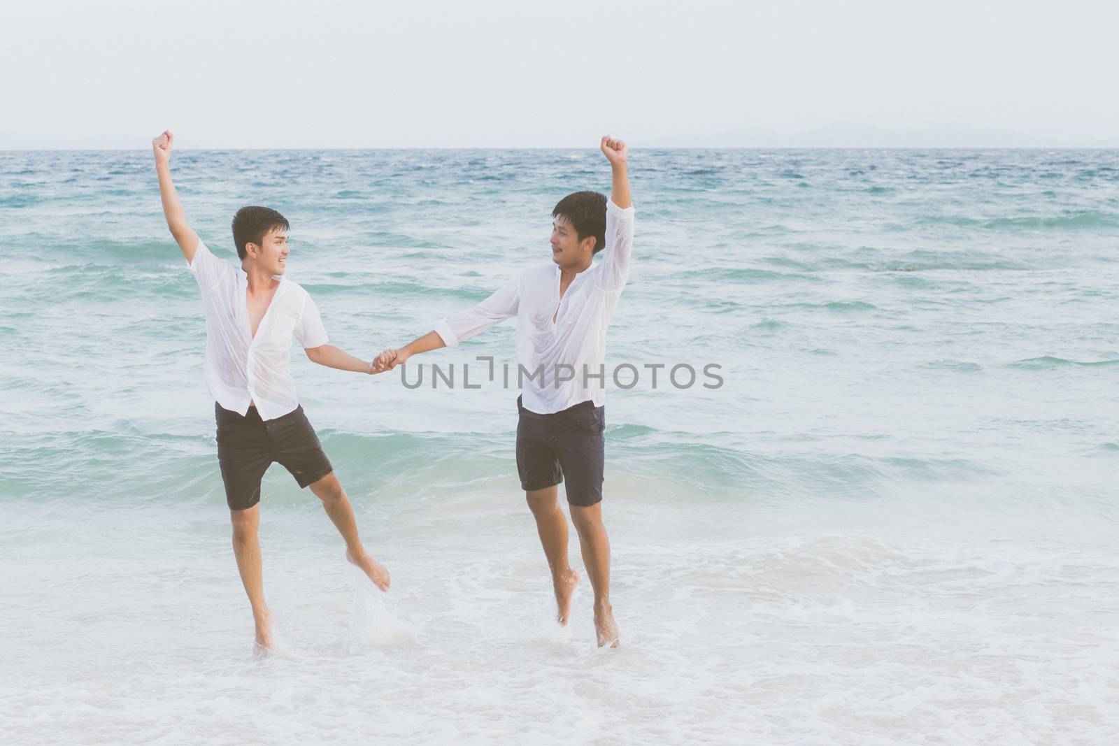 Homosexual portrait young asian couple running and jump with che by nnudoo
