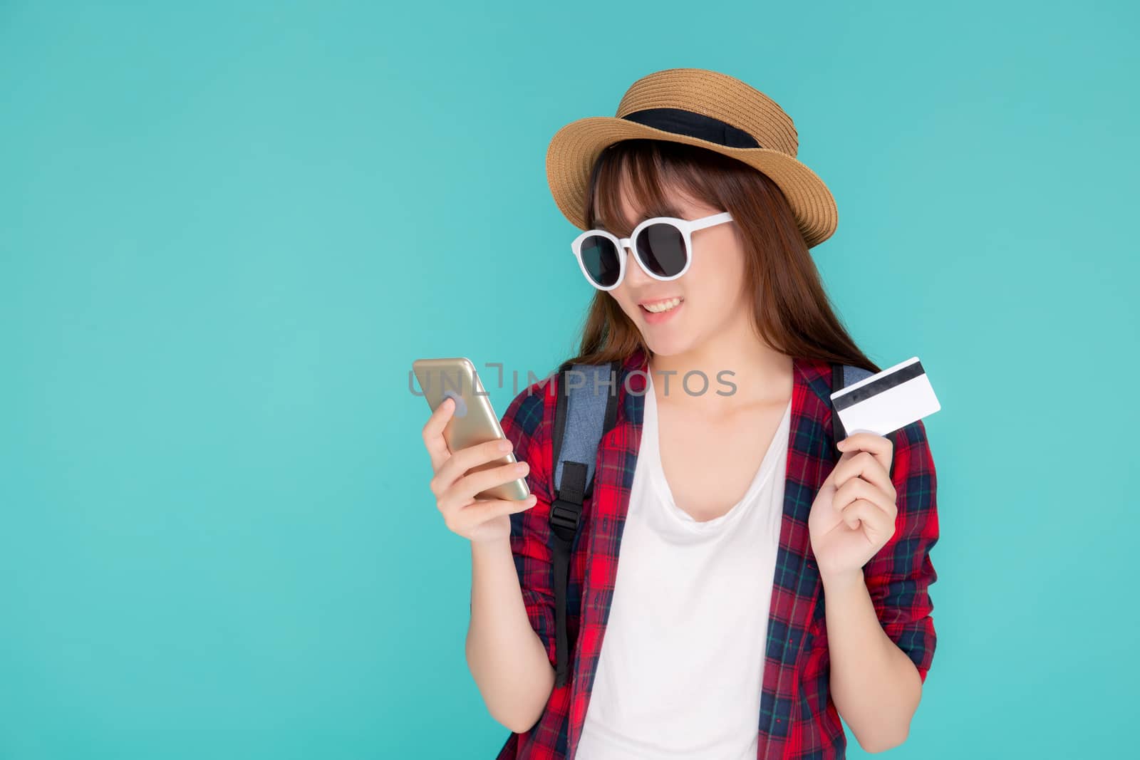 Beautiful portrait young asian woman wear travel summer fashion holding credit card and smart mobile phone in summer, asia girl payment for booking internet online with app in vacation.