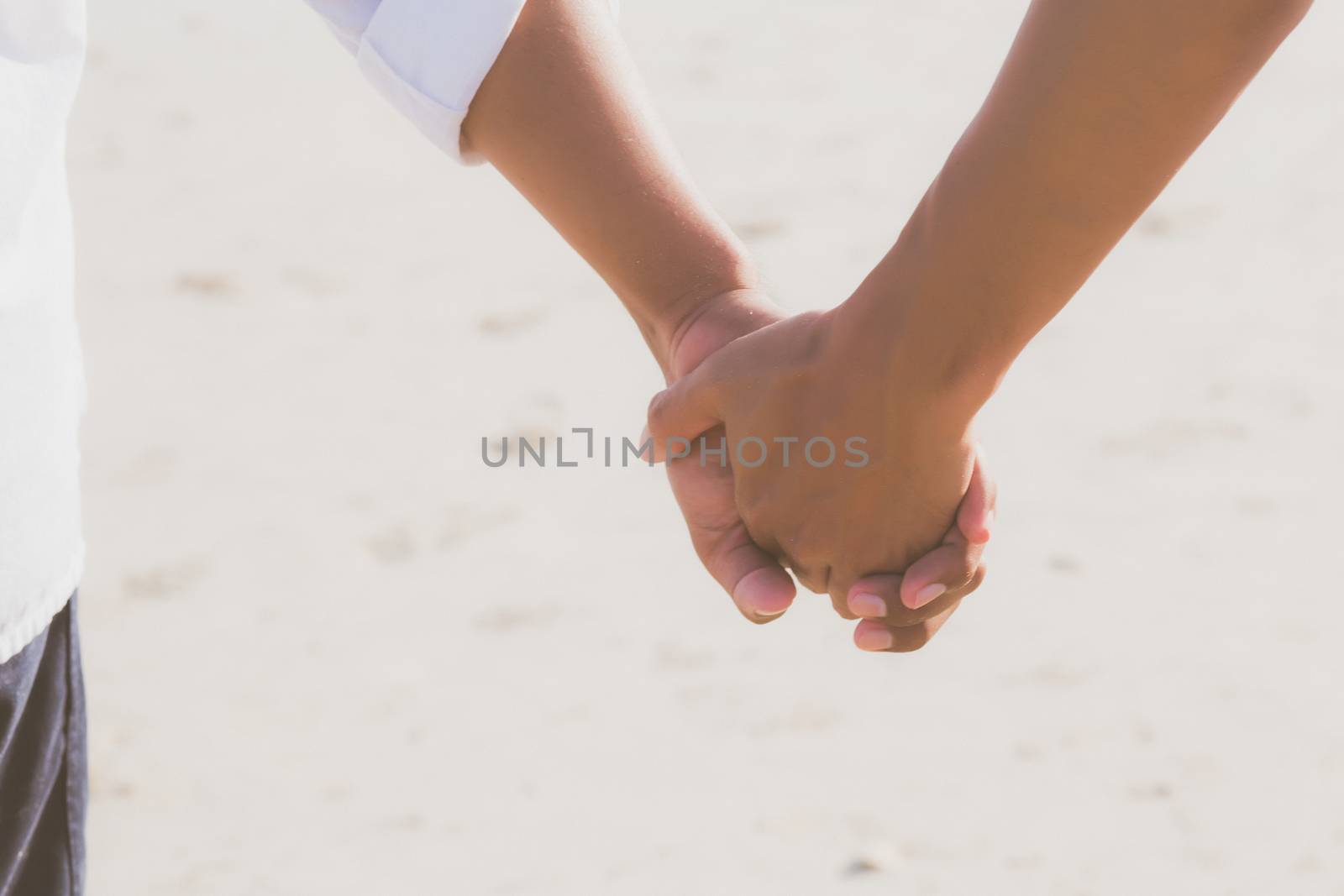 Closeup asian gay couple holding hands together on the beach with relax and leisure in summer, LGBT homosexual legal two man happy and romantic in vacation, relationship sex lover concept.