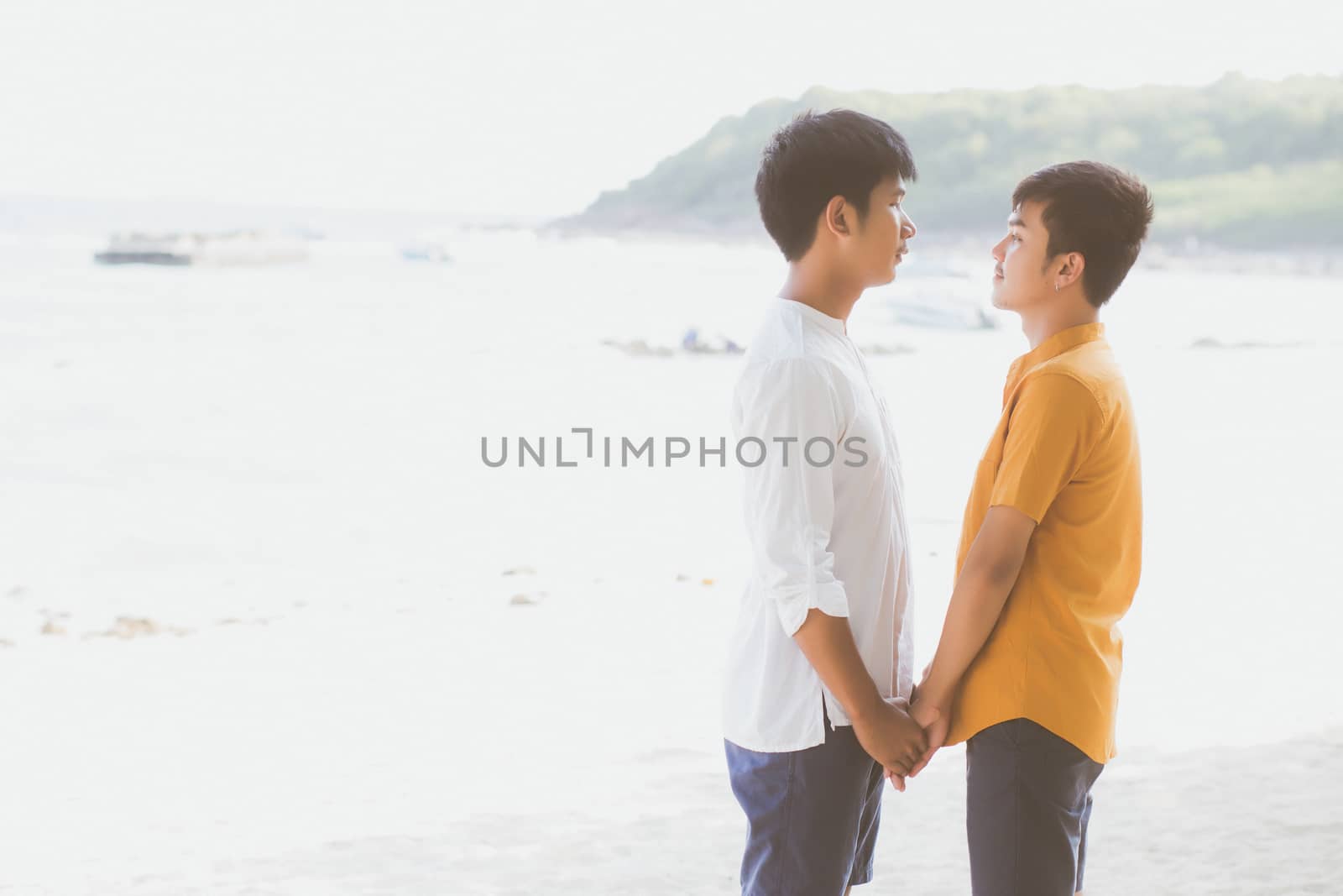 Homosexual portrait young asian couple standing together on beac by nnudoo