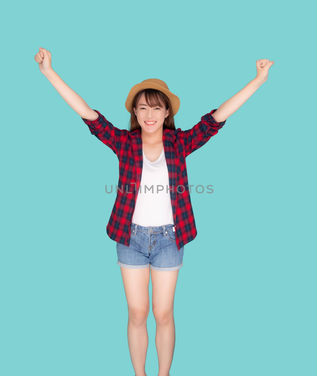 Beautiful young asian woman pulling suitcase isolated on blue background, asia girl having expression is cheerful holding luggage walking in vacation with excited, journey and travel concept.