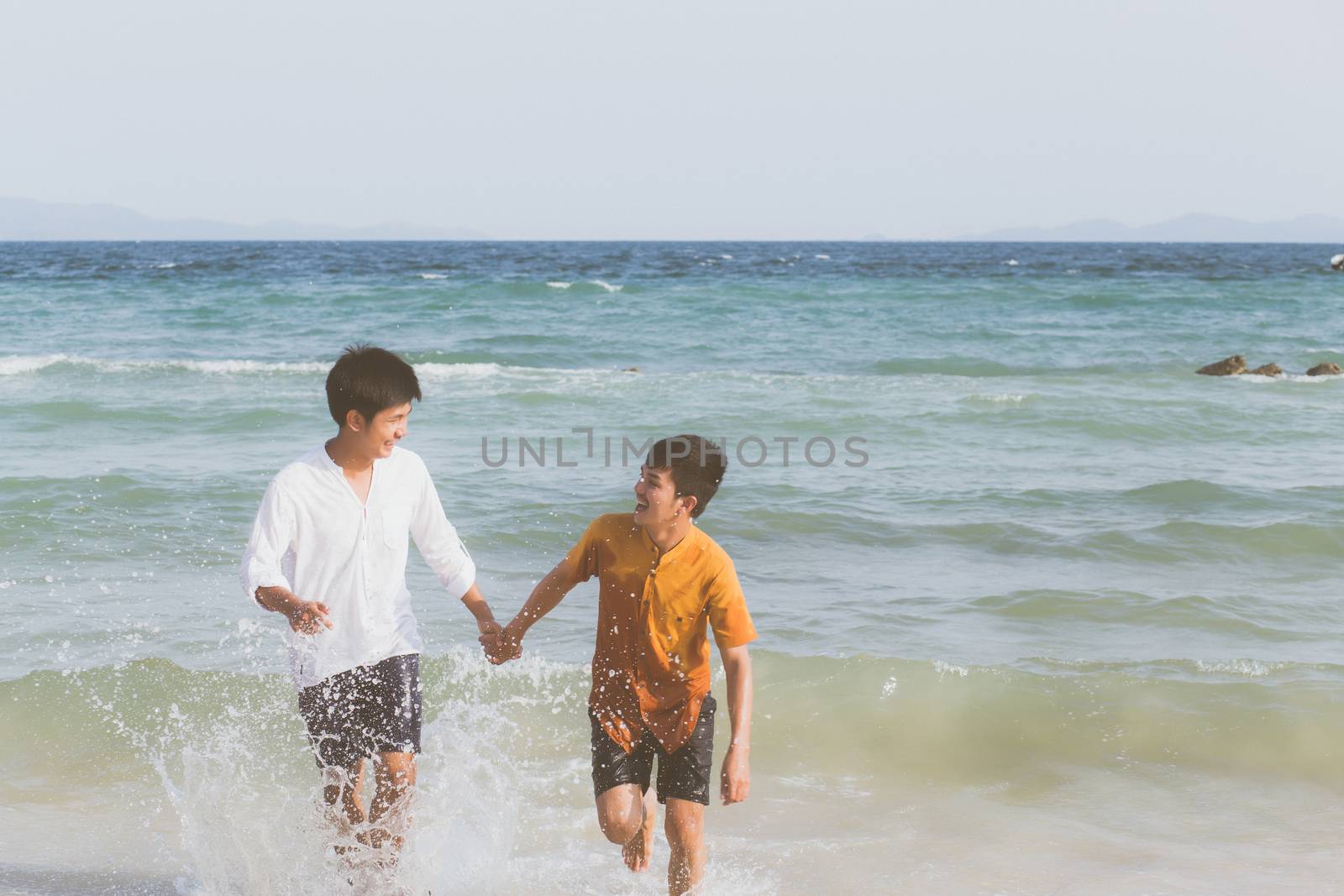 Homosexual portrait young asian couple running with cheerful together on beach in summer, asia gay going tourism for leisure and relax with happiness in vacation at sea, LGBT legal concept.