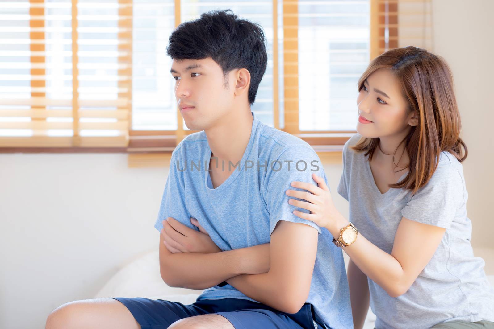 Young asian couple a problem and woman ask forgive and sorry with man feeling angry at bedroom, asia wife excuse convince husband with relationship, family and lifestyle concept.
