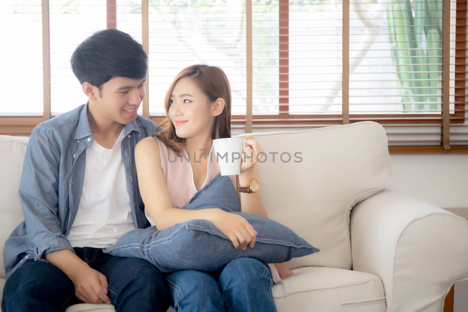 Beautiful young asian couple smiling and talking story married s by nnudoo
