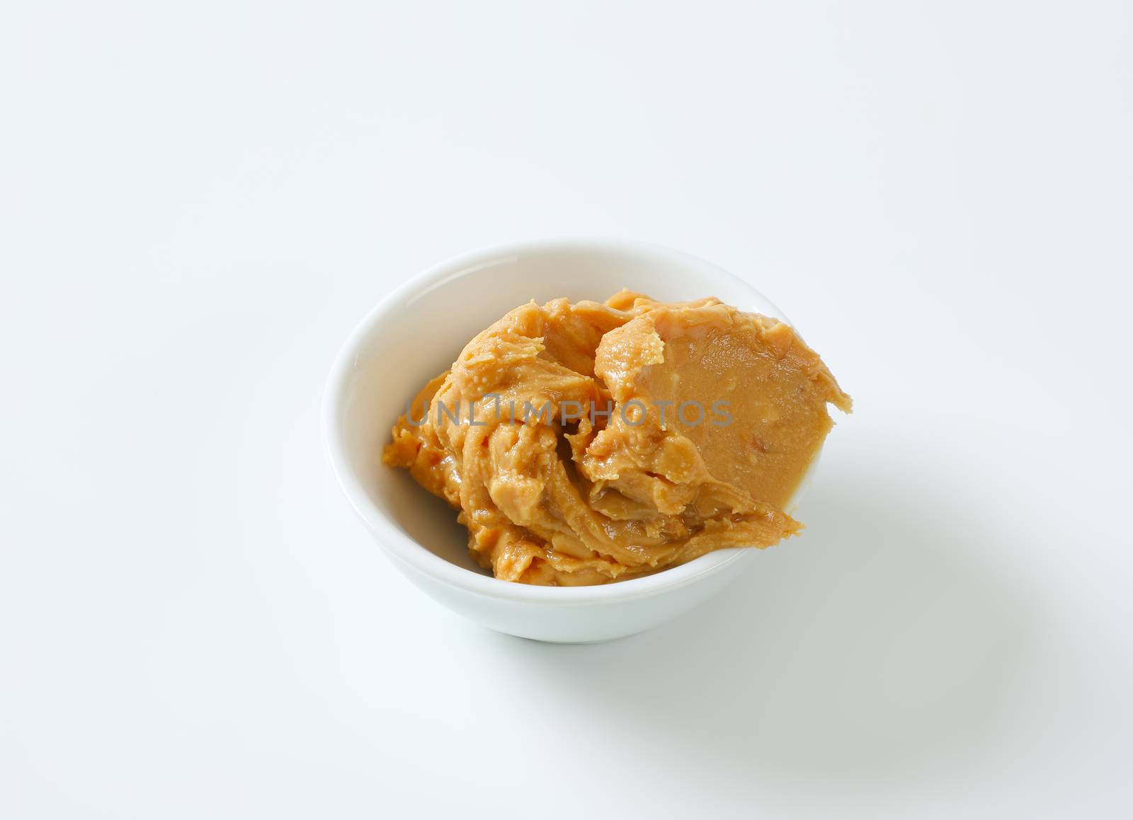 Crunchy peanut butter in white bowl