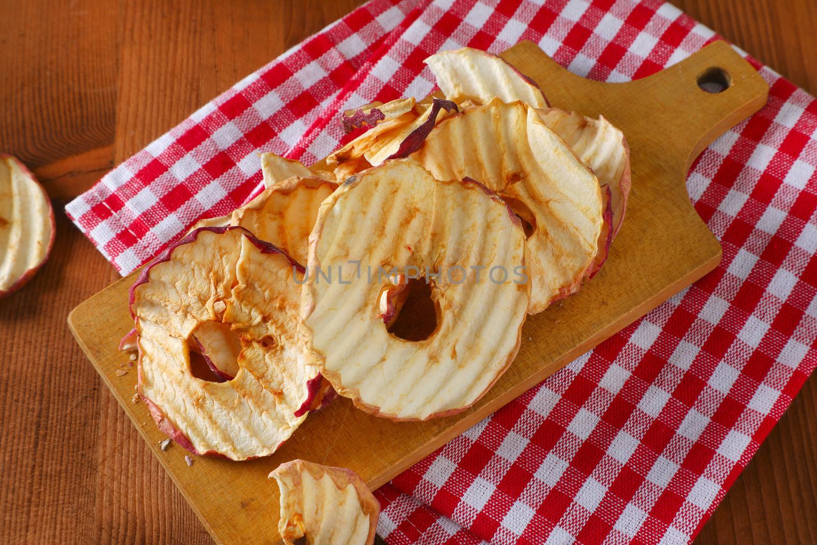 Dried apple chips or rings on cutting board
