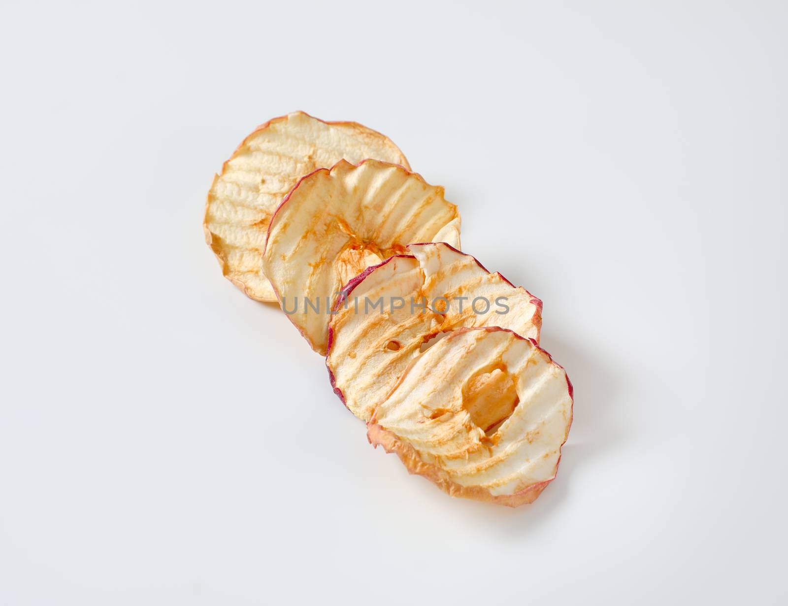 Dried apple slices (apple chips or rings) in a row