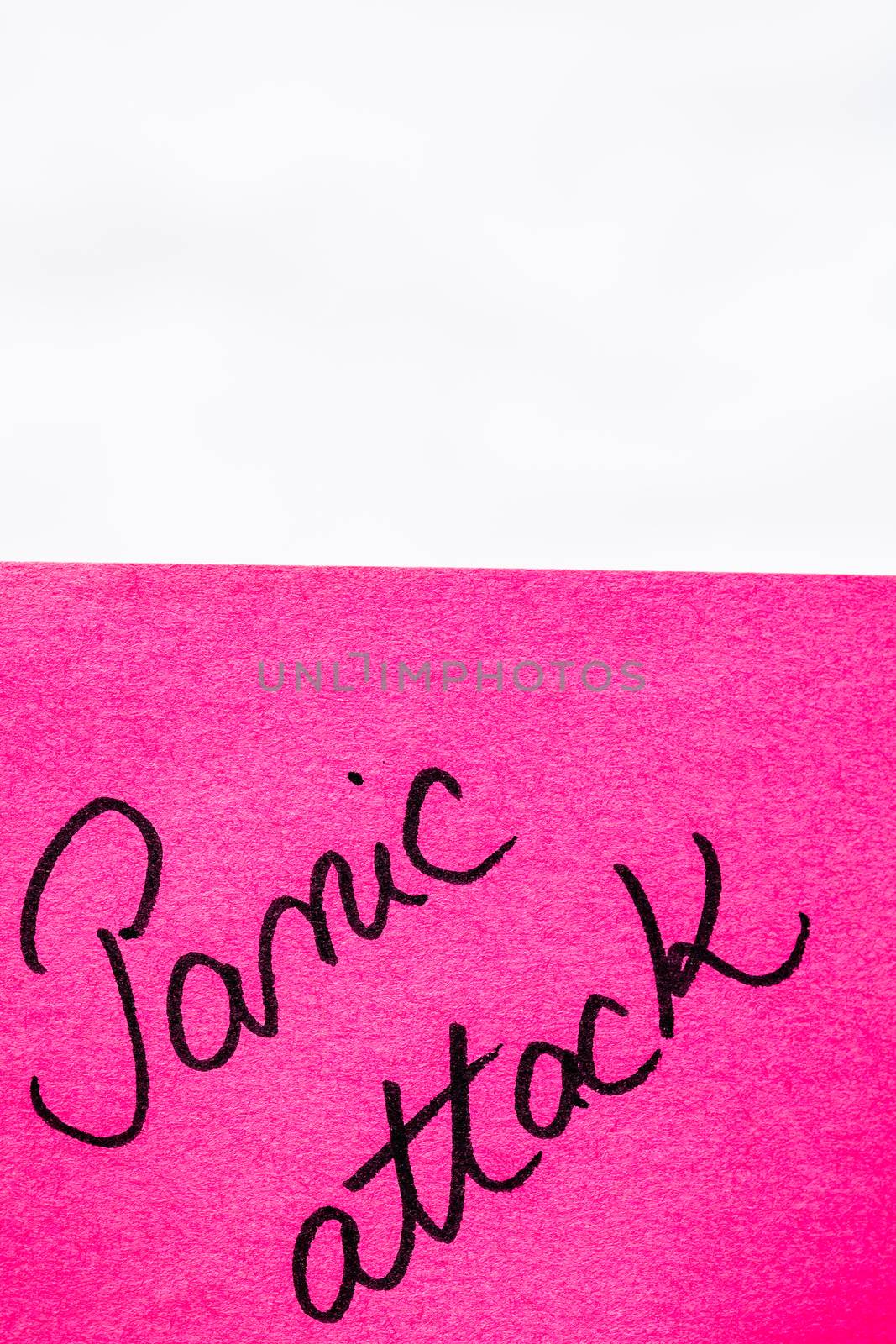 Panic attack handwriting text close up isolated on pink paper wi by vladispas