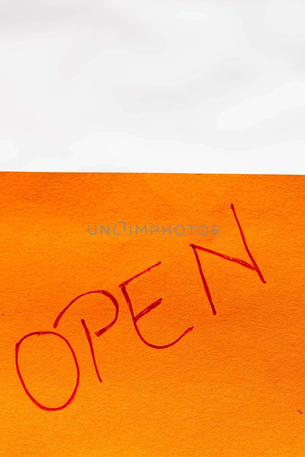 Open handwriting text close up isolated on orange paper with copy space.