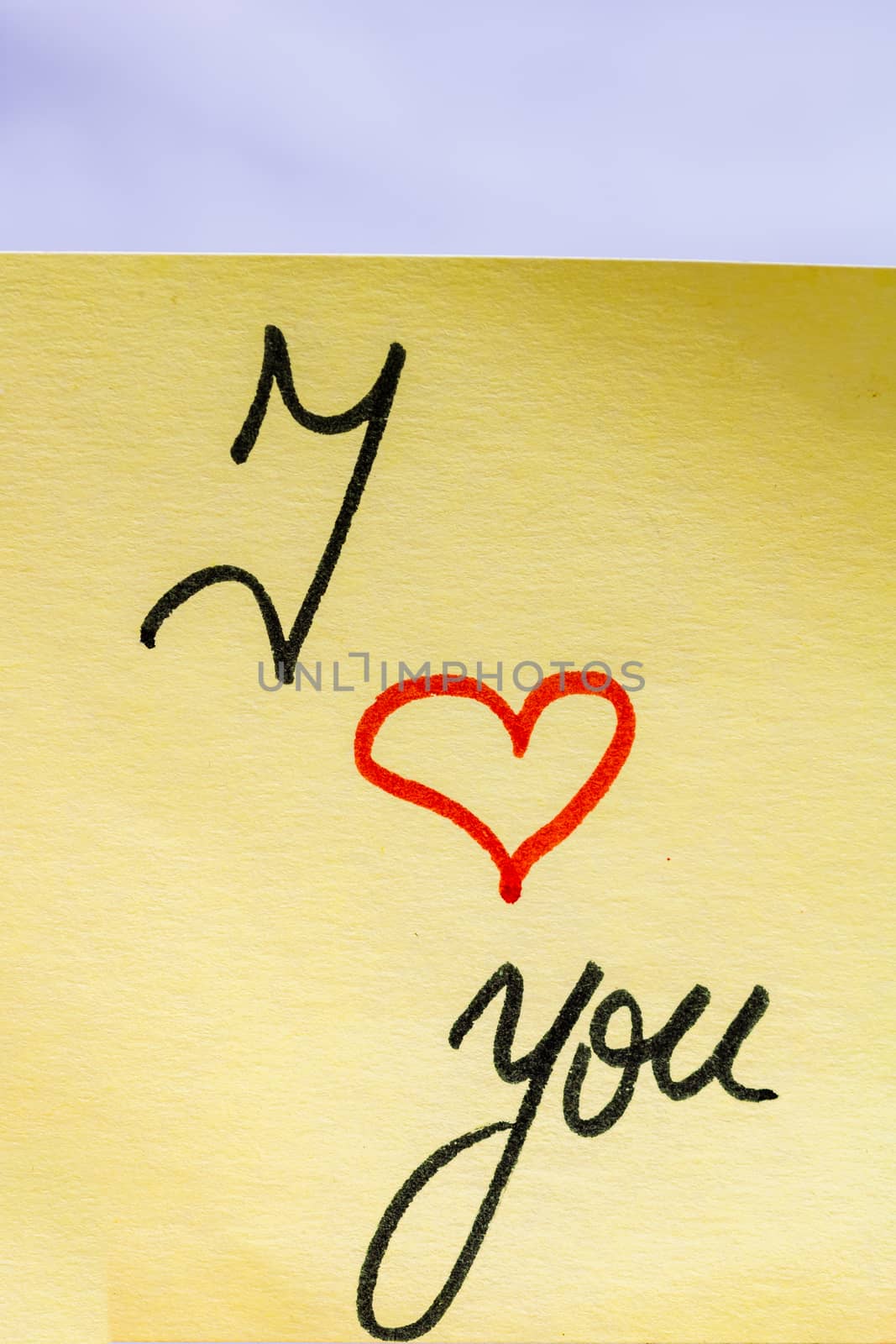 I love you handwriting text close up isolated on yellow paper wi by vladispas