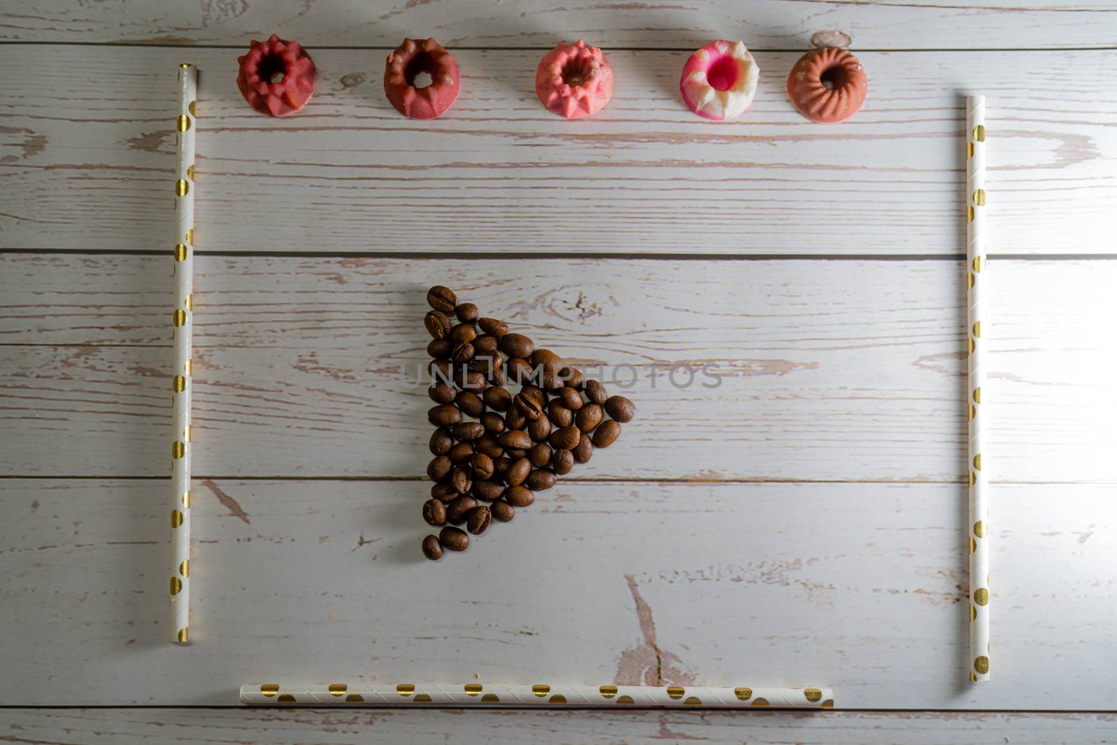 flatlay concept abstract showing coffee beans, straws, candies candles on a white wooden background perfect for a cafe menu or restaurant with copyspace by Shalinimathur