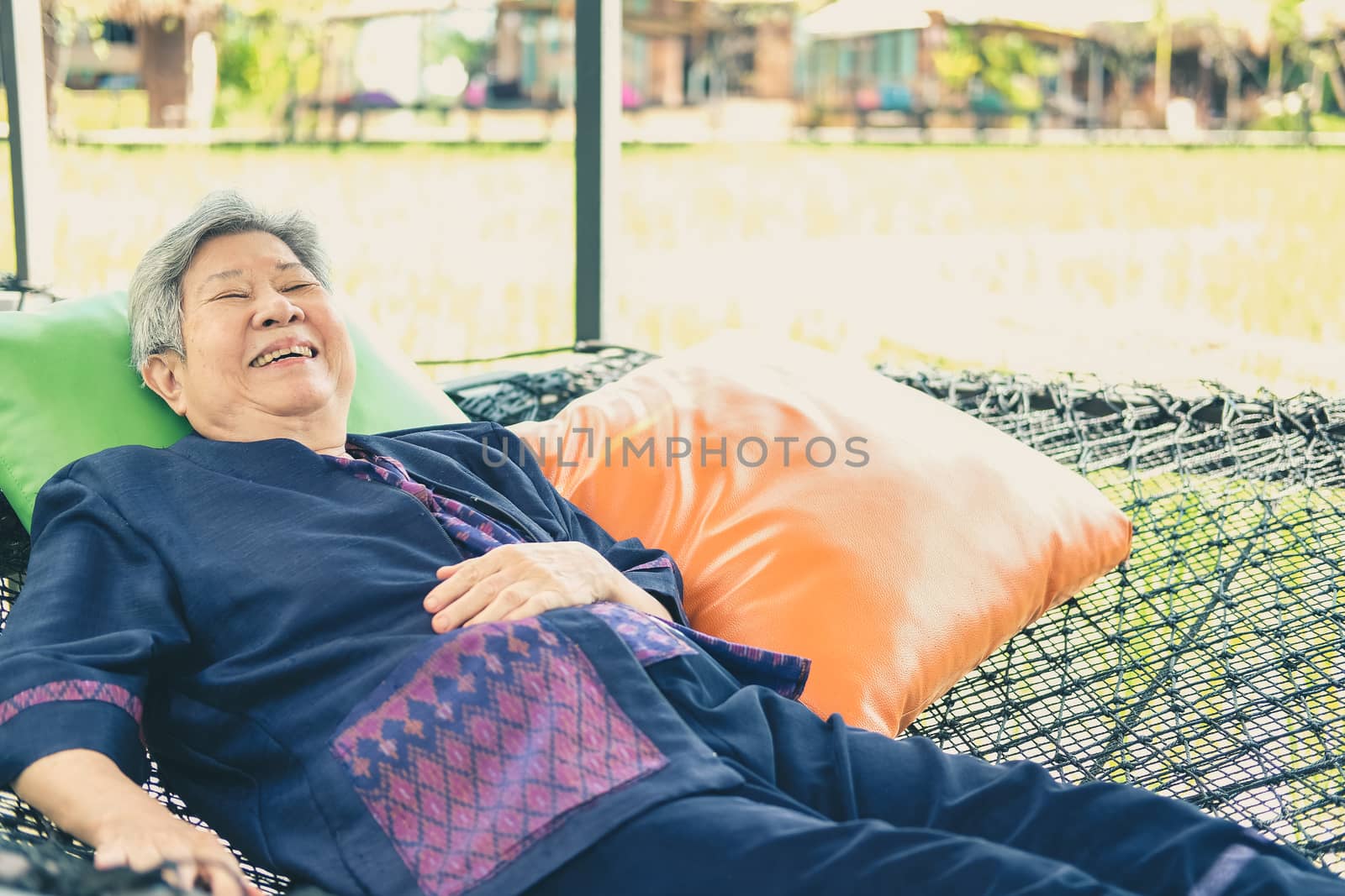 asian elderly woman elder  lying resting relaxing outdoors. senior leisure lifestyle