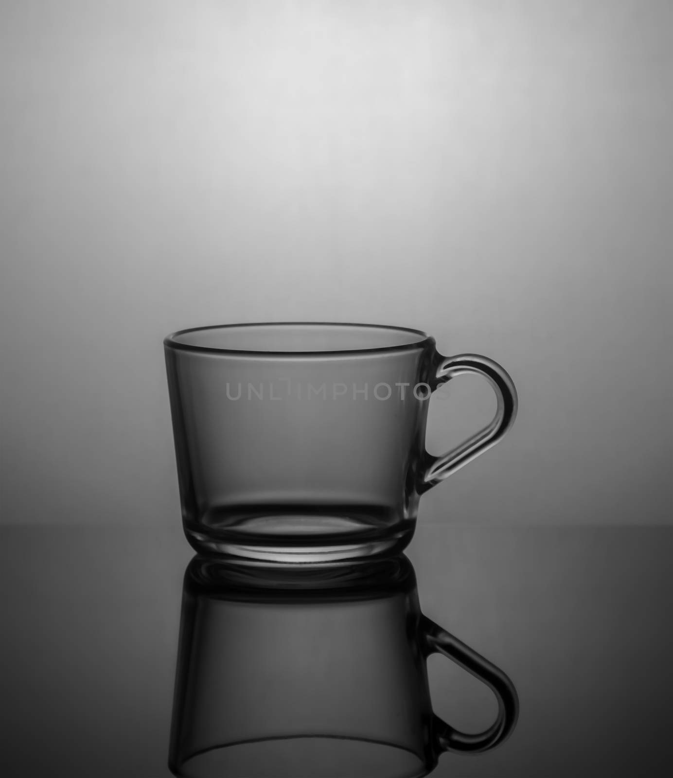 Empty tea cup on dark background with back light.