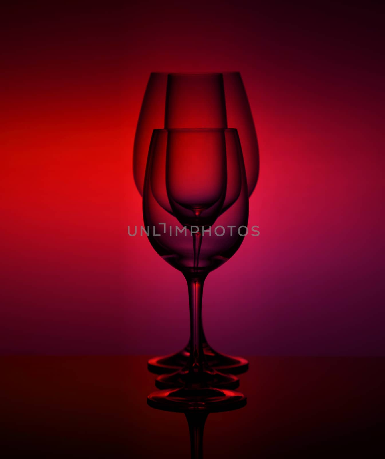 close-Up view Of various empty Glasses Against Colored Background.