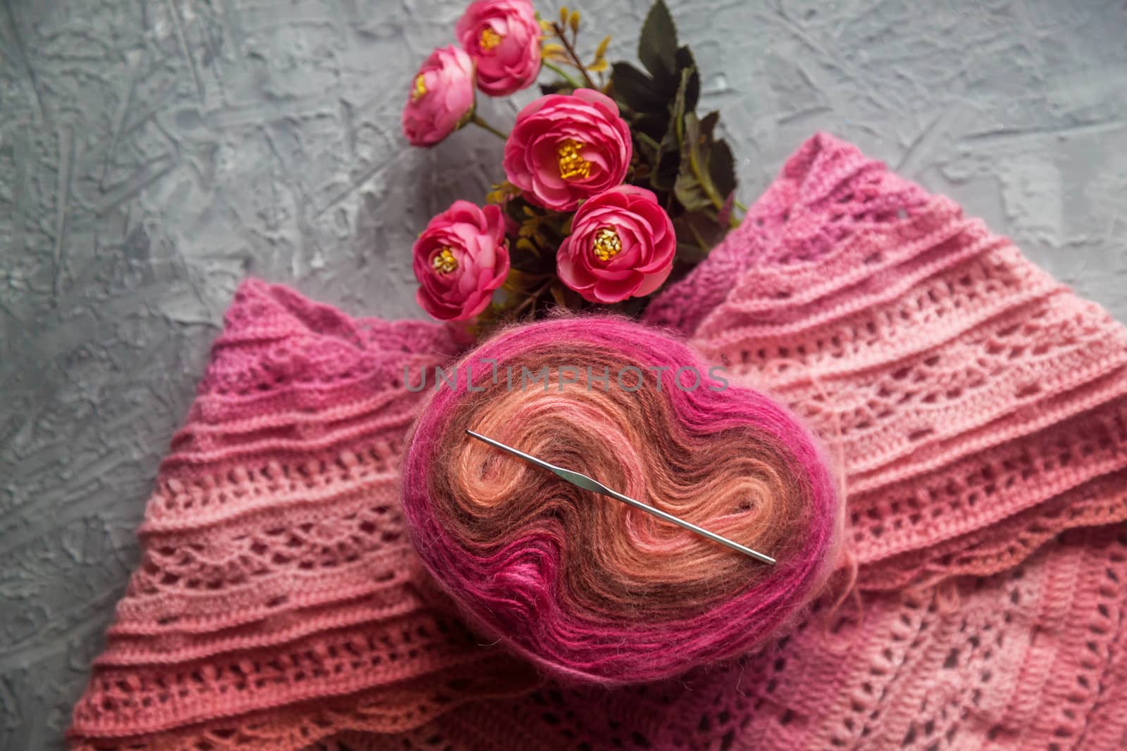 Crochet background flatlay. Crochet hook and scarf on a concrete background by galinasharapova