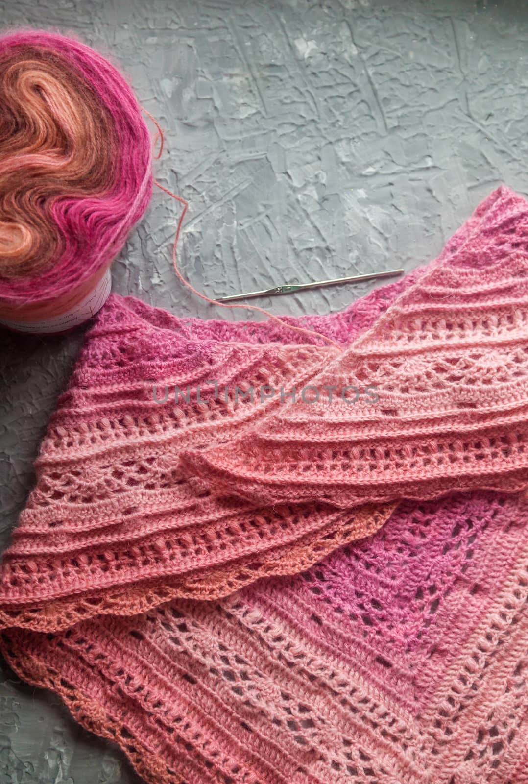 Crochet background flatlay. Crochet hook and scarf on a concrete background by galinasharapova