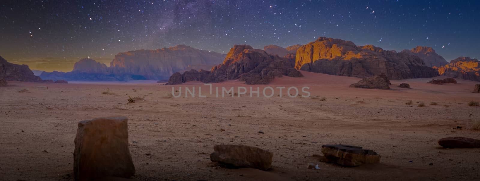 Desert and rocks on extraterrestrial or alien planet in the universe with view on space and galaxy. Sci-fi.