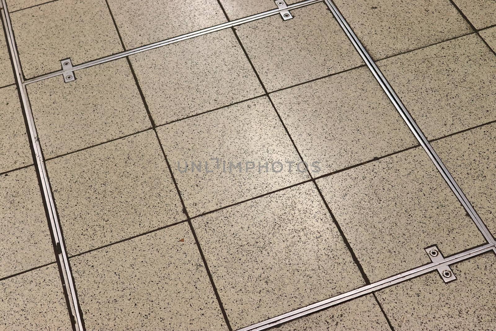 Detailed close up texture on structured floor tiles on a ground