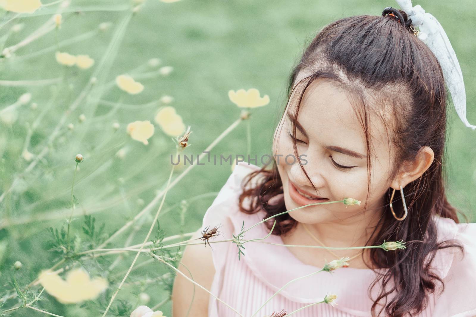Portrait of asian happy woman smilling with flower garden , Selective focus