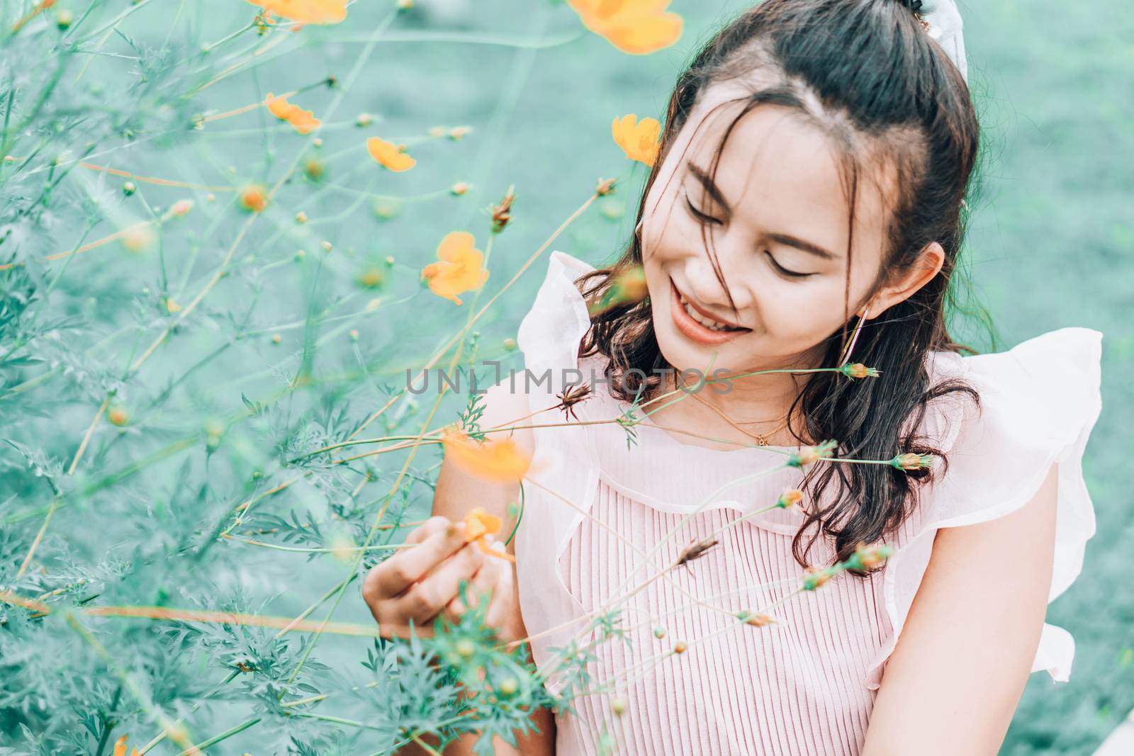 Portrait of asian happy woman smilling with flower garden , Selective focus