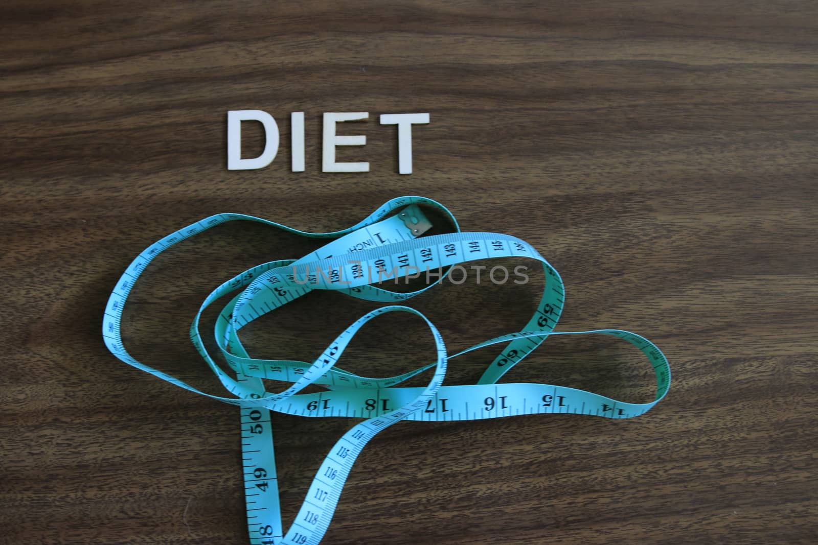 the word diet next to measuring tape. theme of losing weight by mynewturtle1