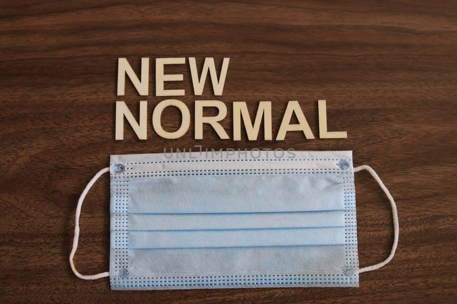 the term new normal on wood background by mynewturtle1